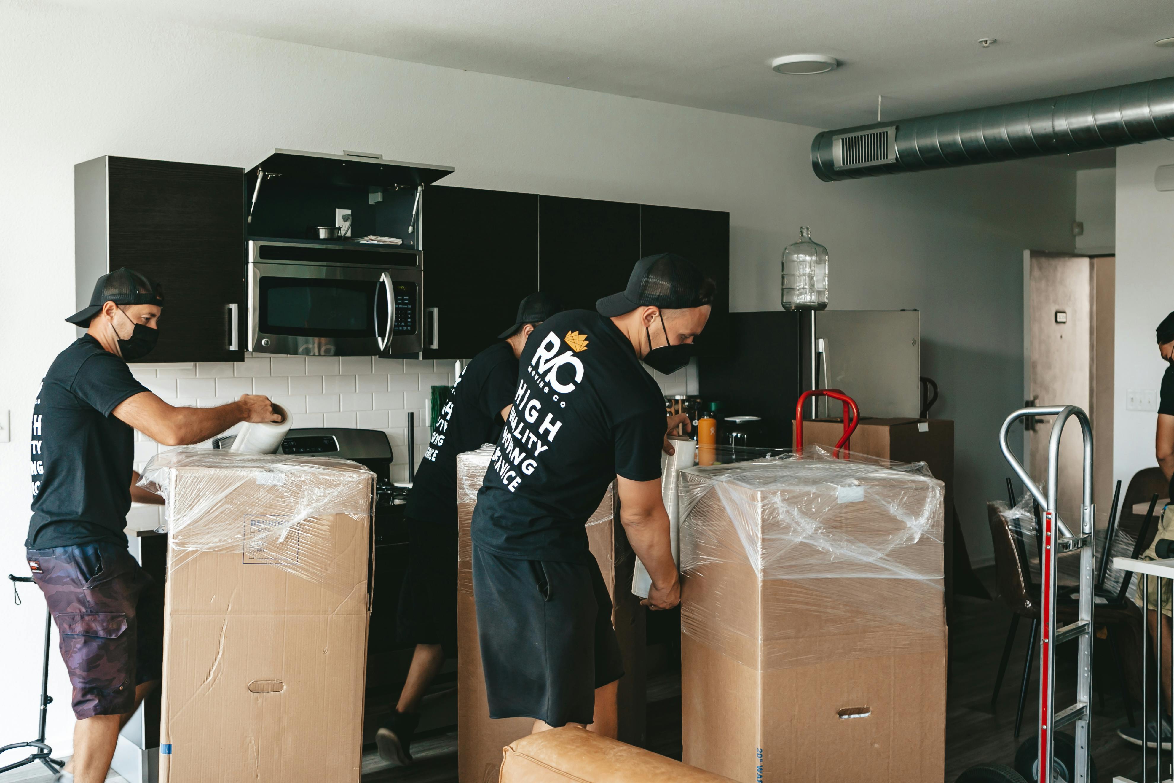 Men with Boxes in Kitchen