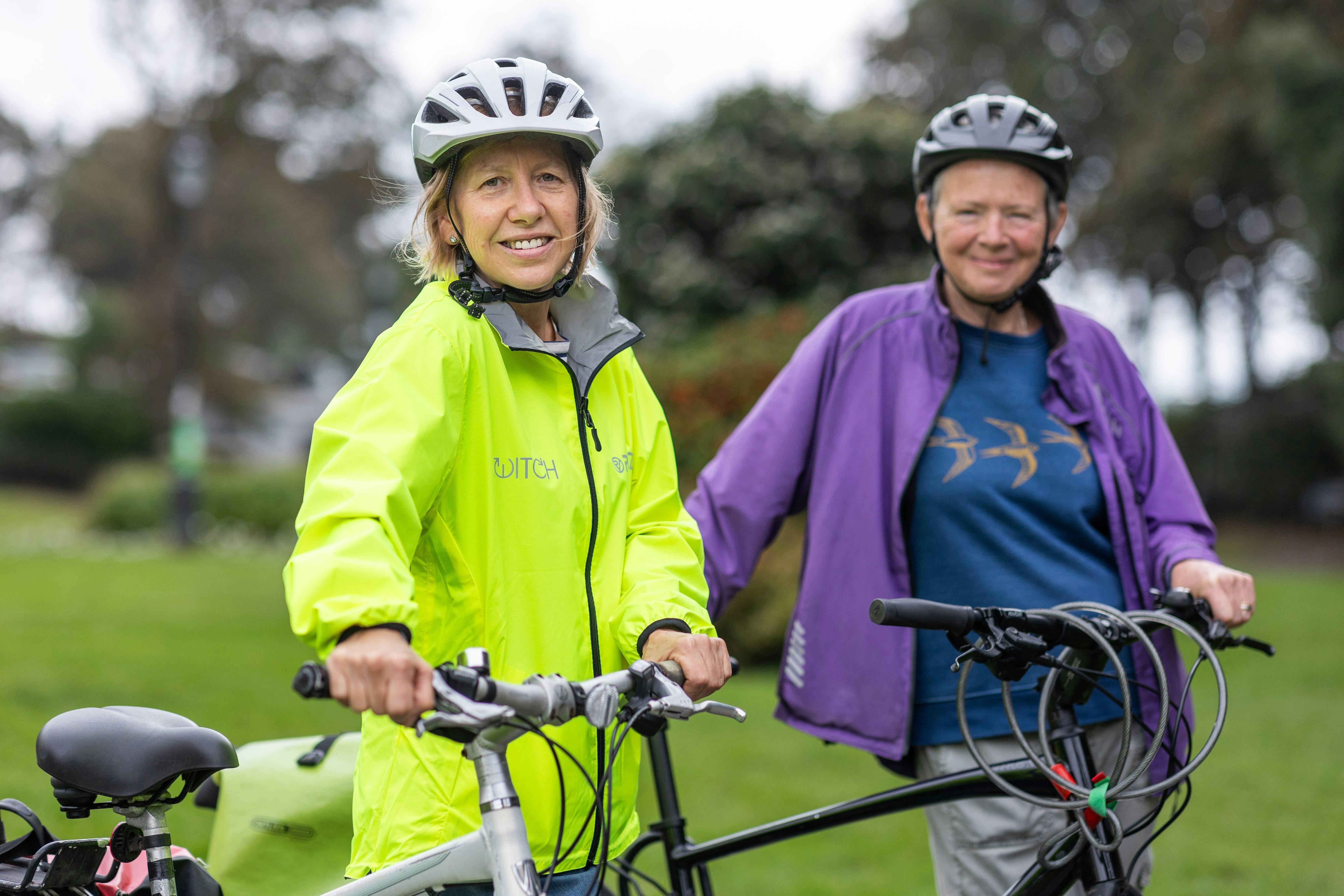 Women in Helmets Standing with Bicycles