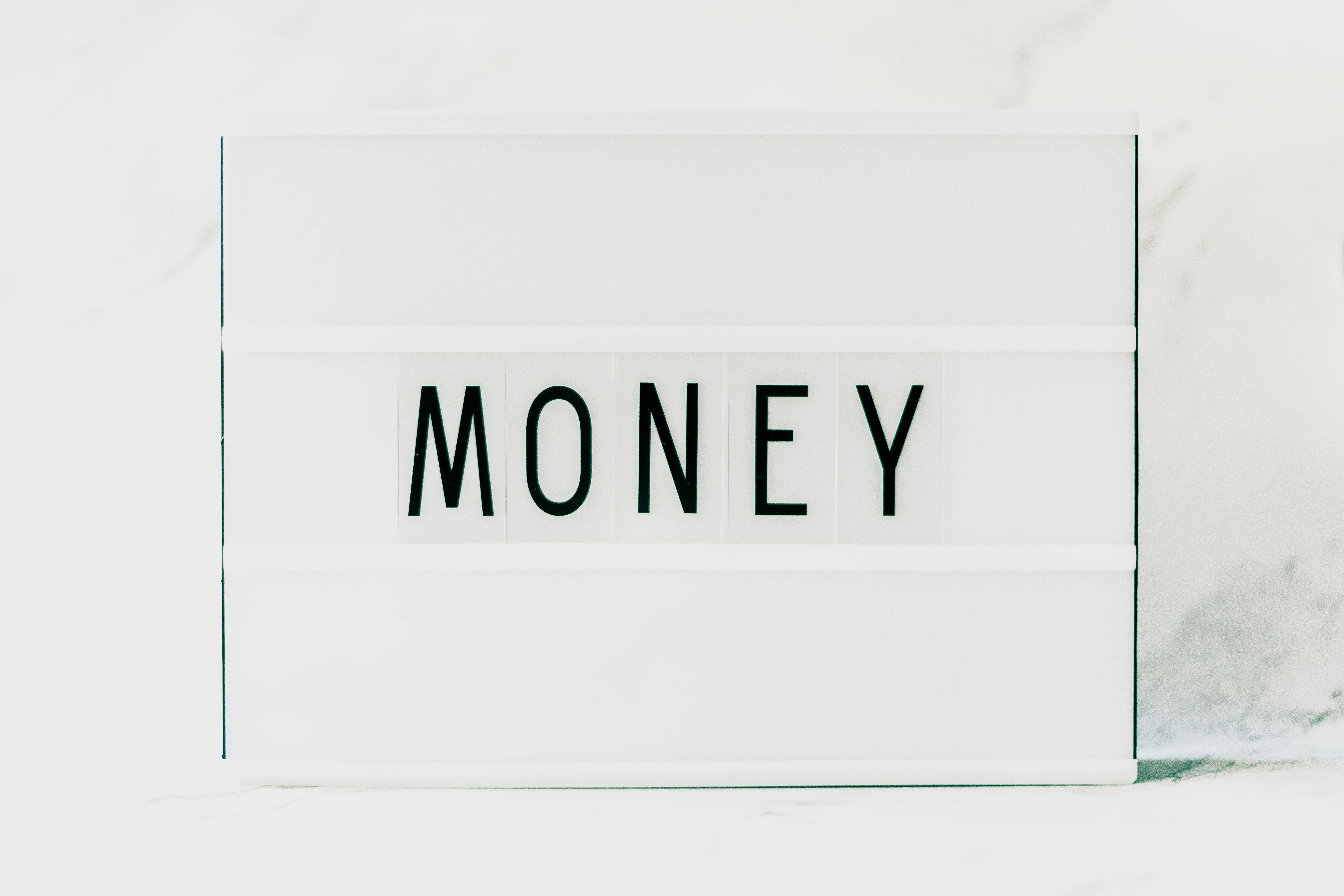 Close-up of a Light Box with a Word "Money" in the Middle