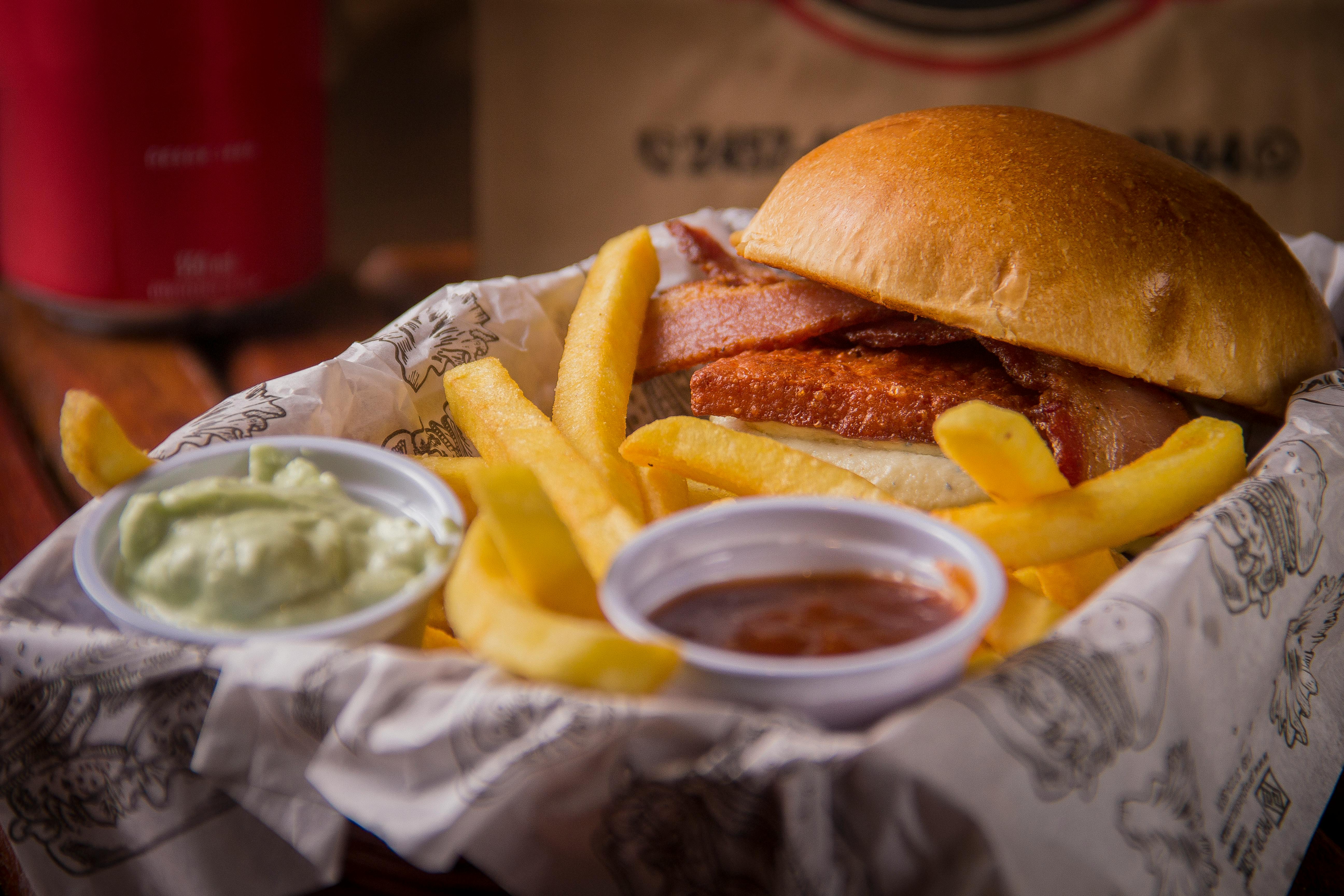 Close-up of a Burger with Fries and Sauce