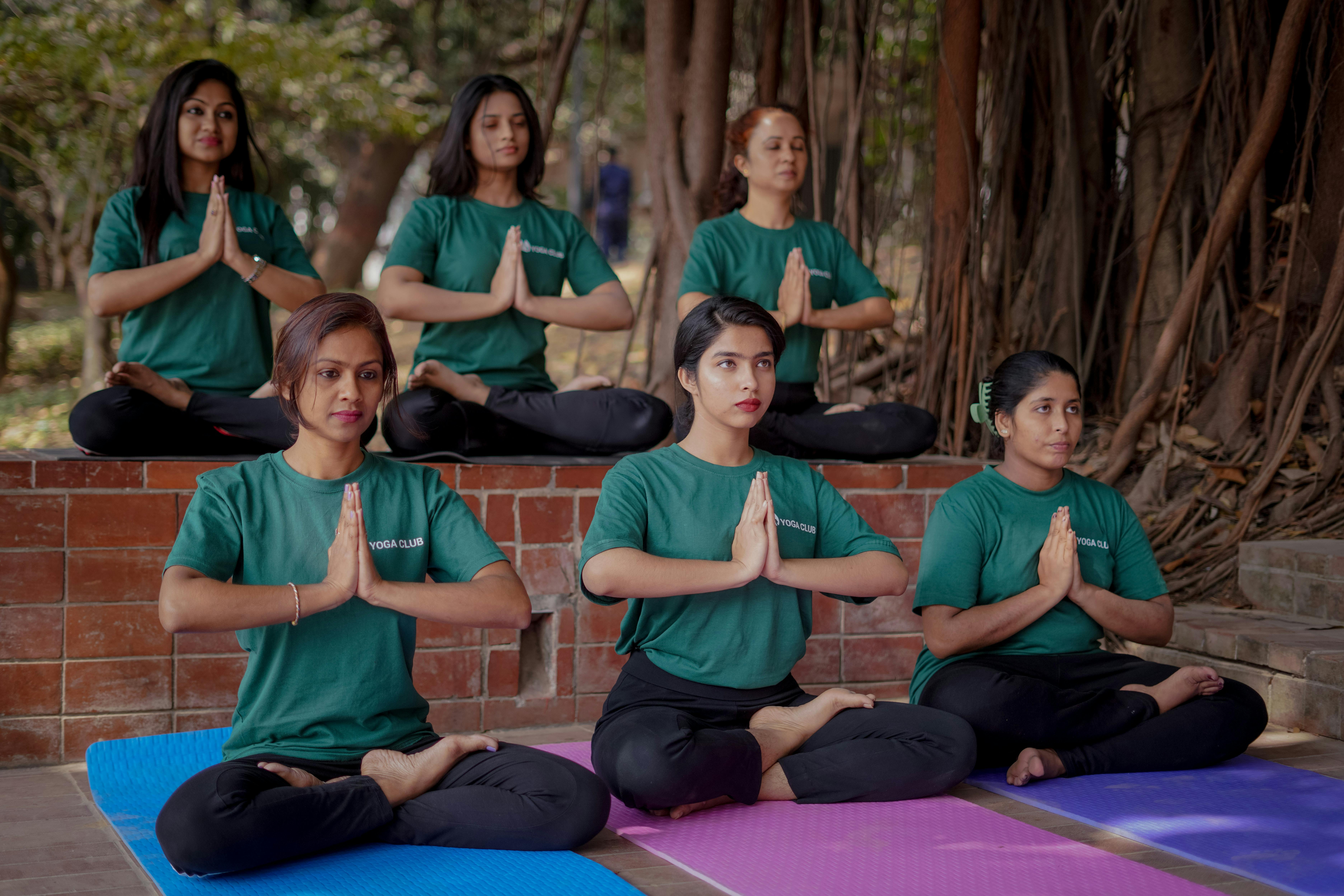 Women Sitting and Exercising Yoga