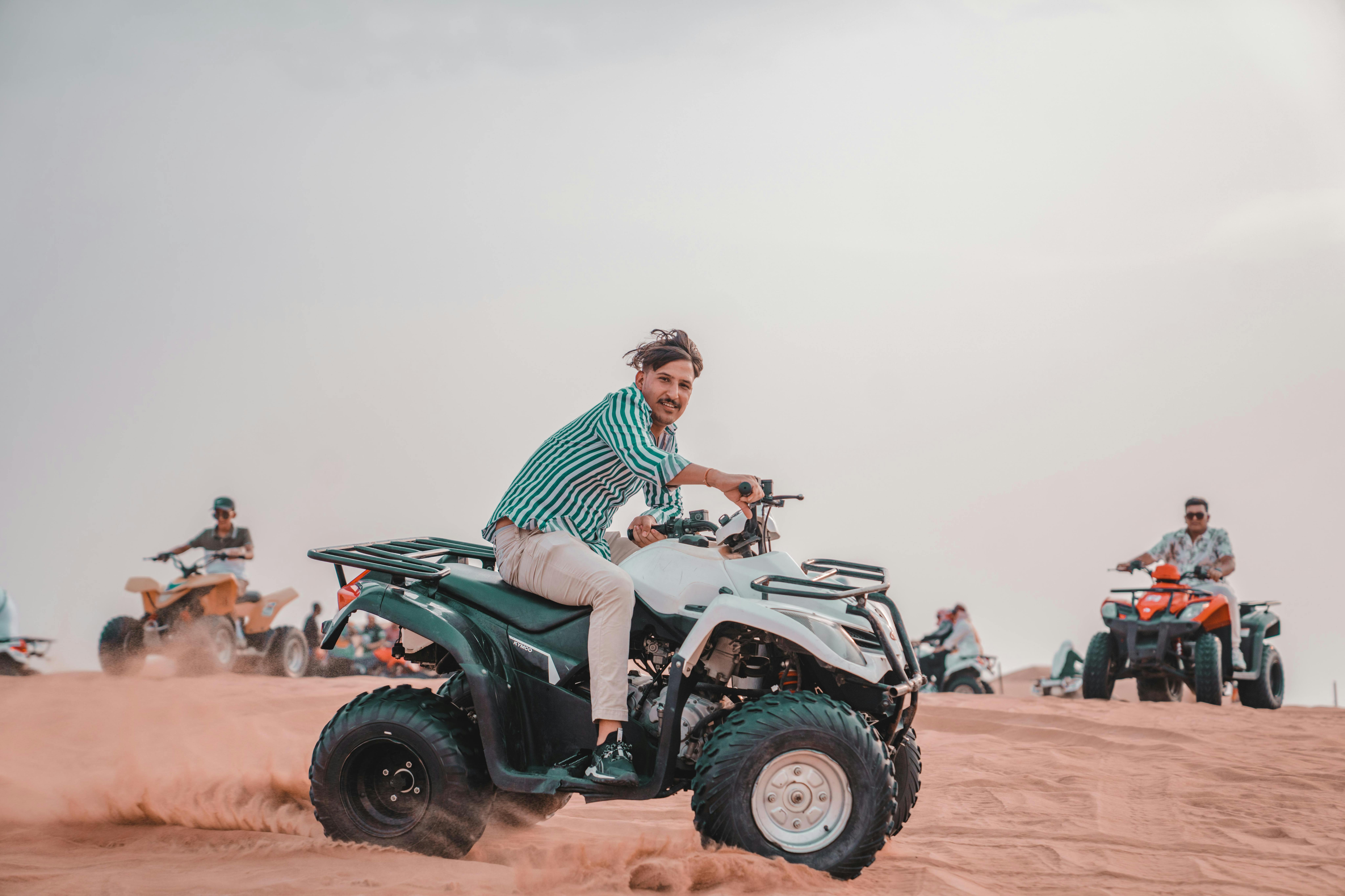Man and People on Quads on Desert