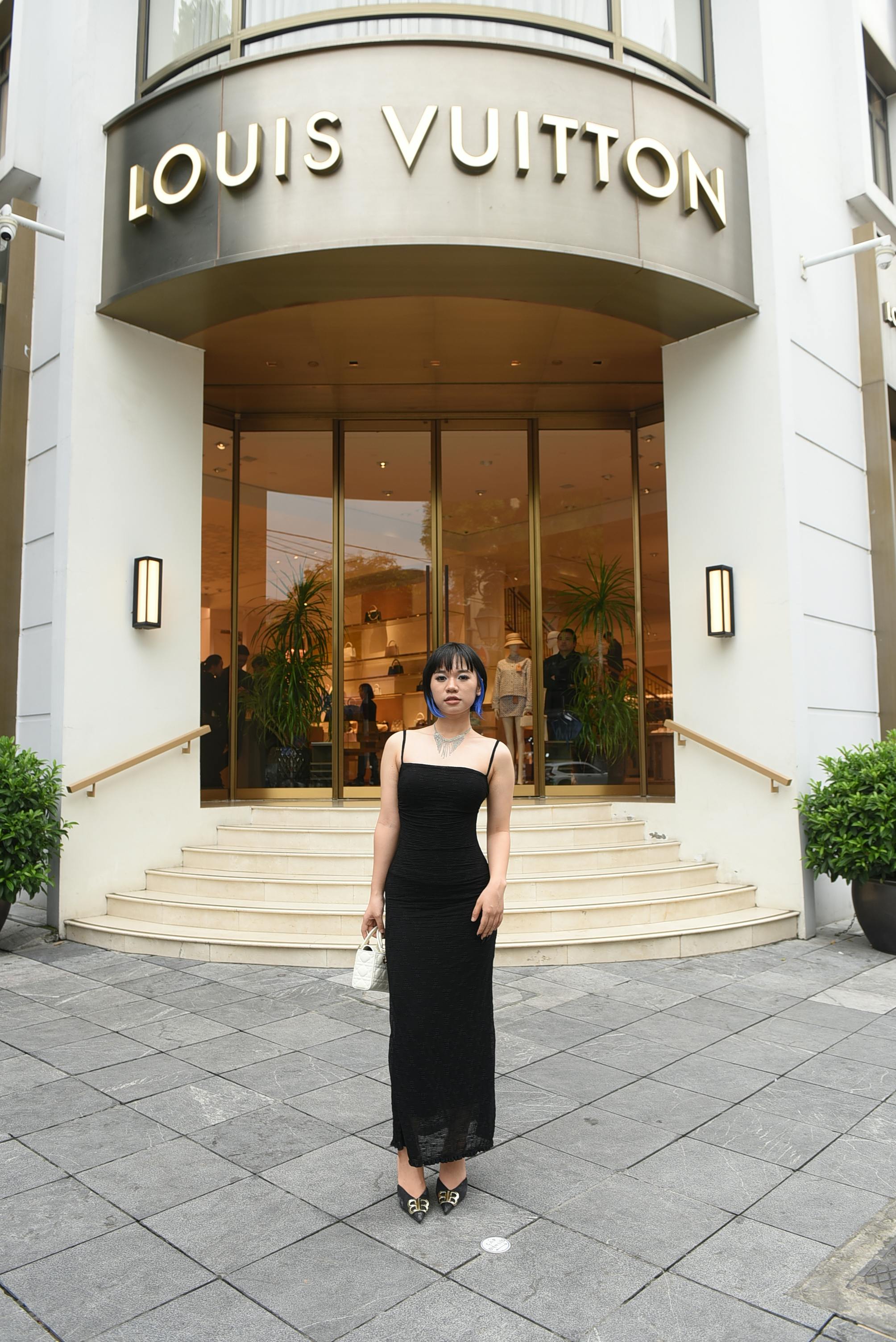Brunette in Black Dress in front of Brand Store