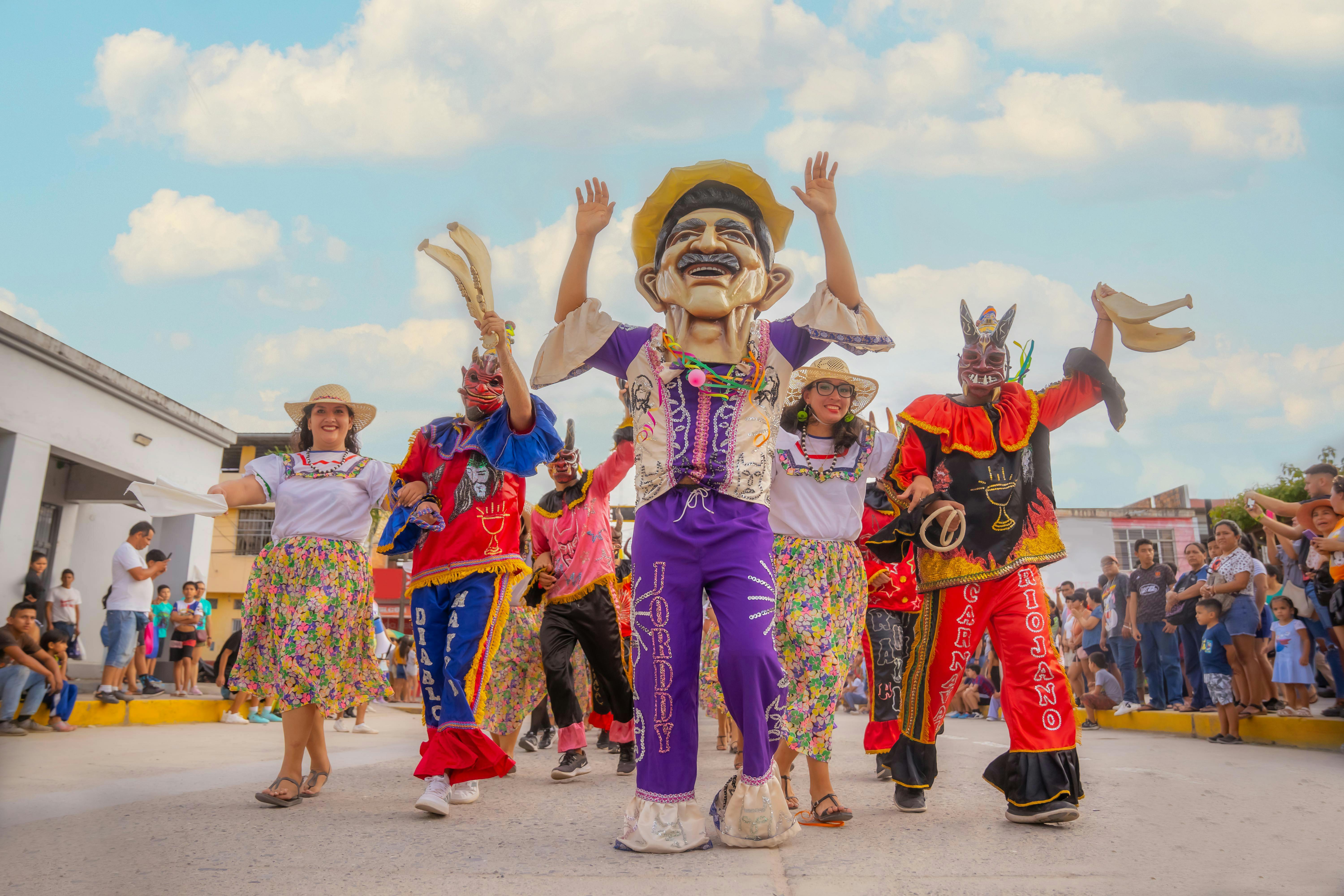 People in Costumes and Women in Traditional Dresses Walking in Parade