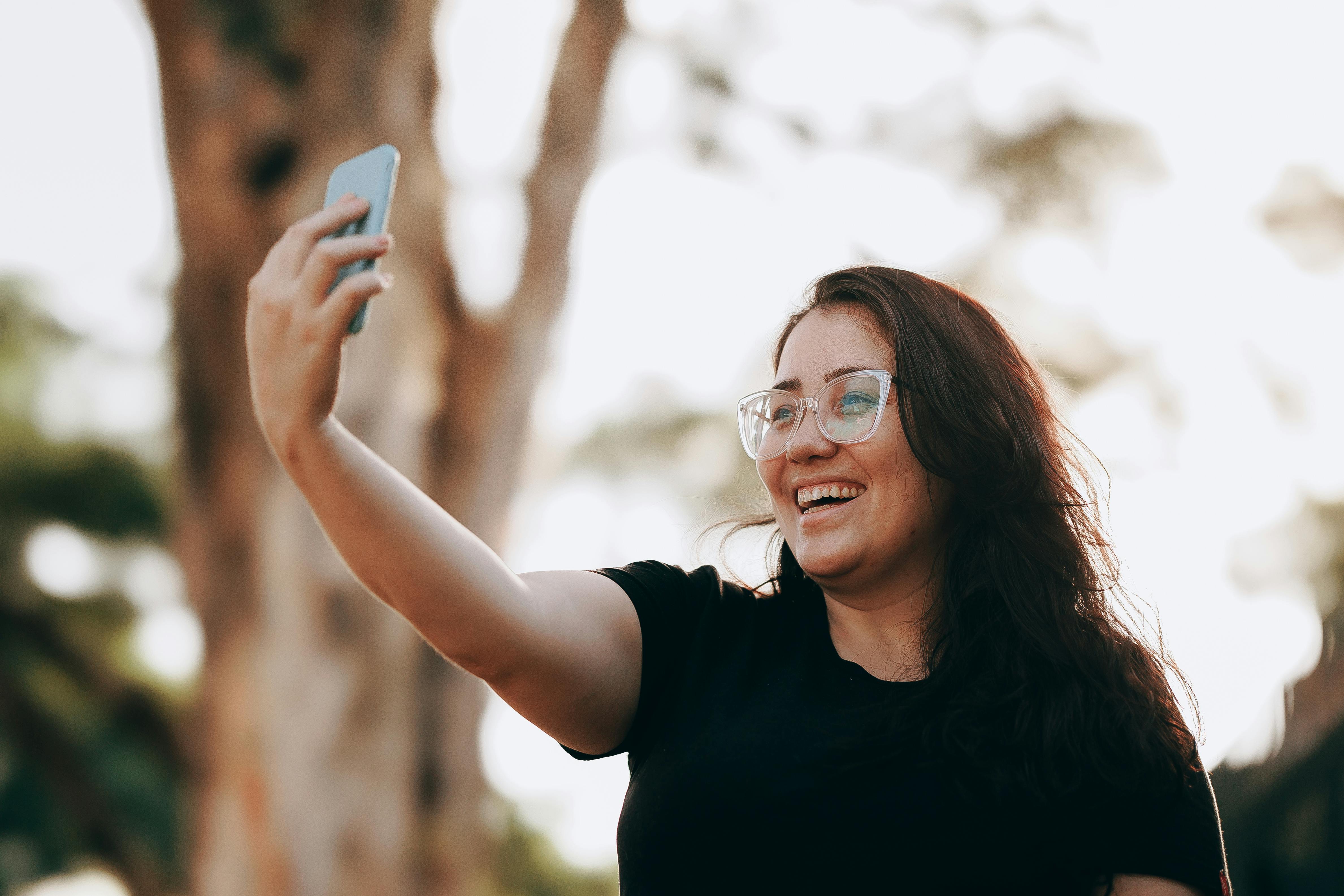 A Woman Smiling to the Smartphone