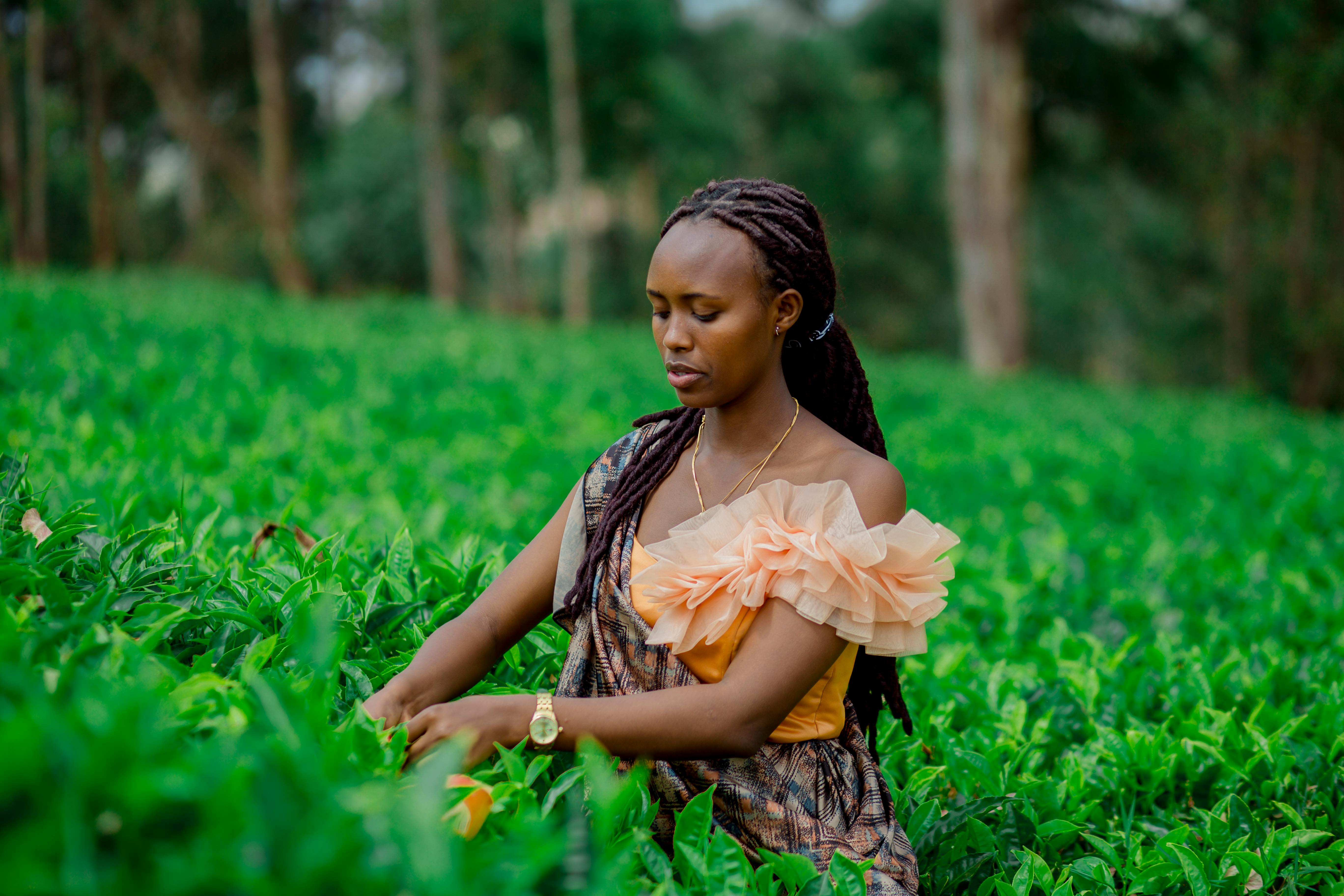 Woman in Traditional Clothing Working on Rural Field