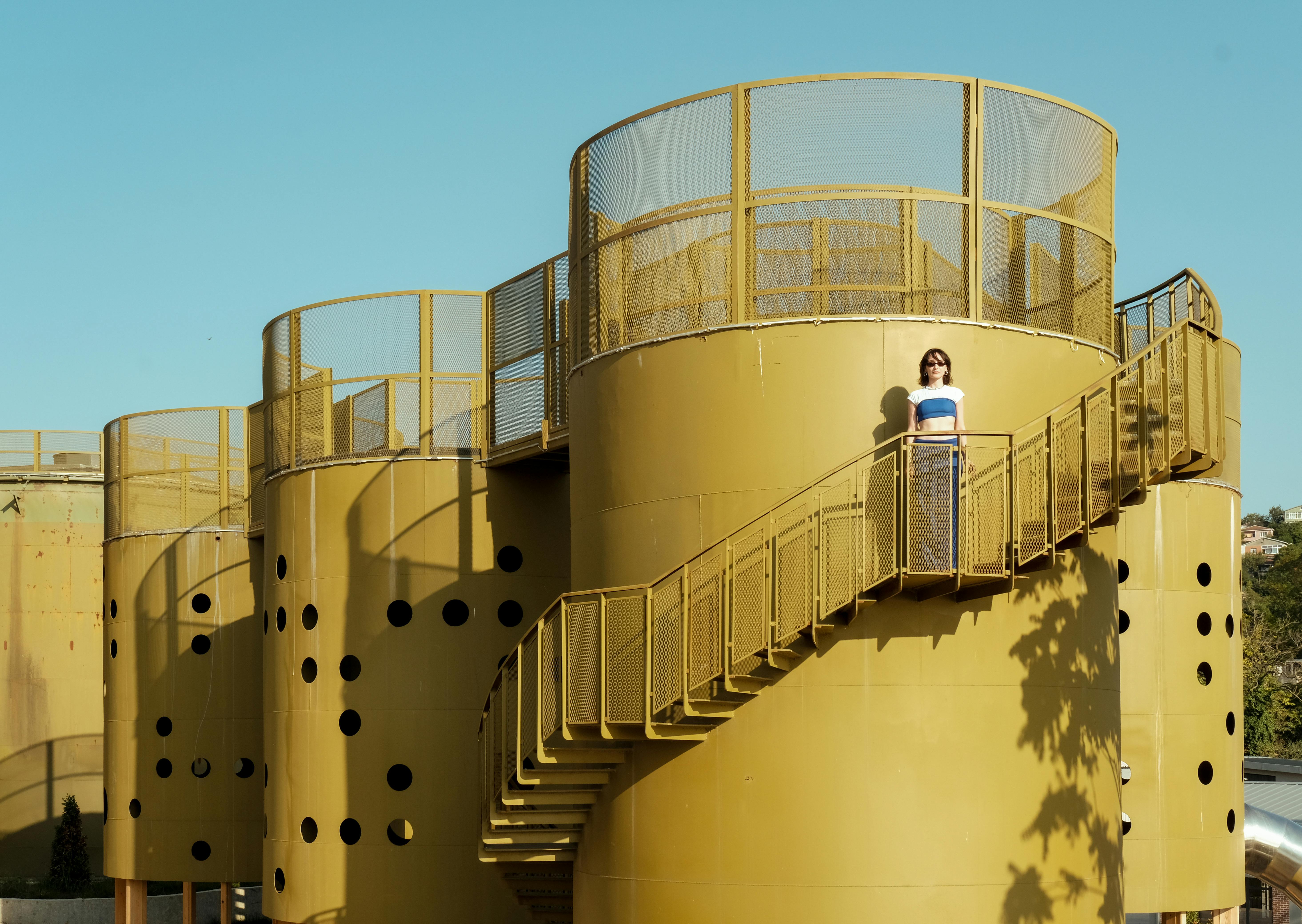 A Woman Standing on the Stairs of the Cubuklu Oil Silos in Istanbul, Turkey