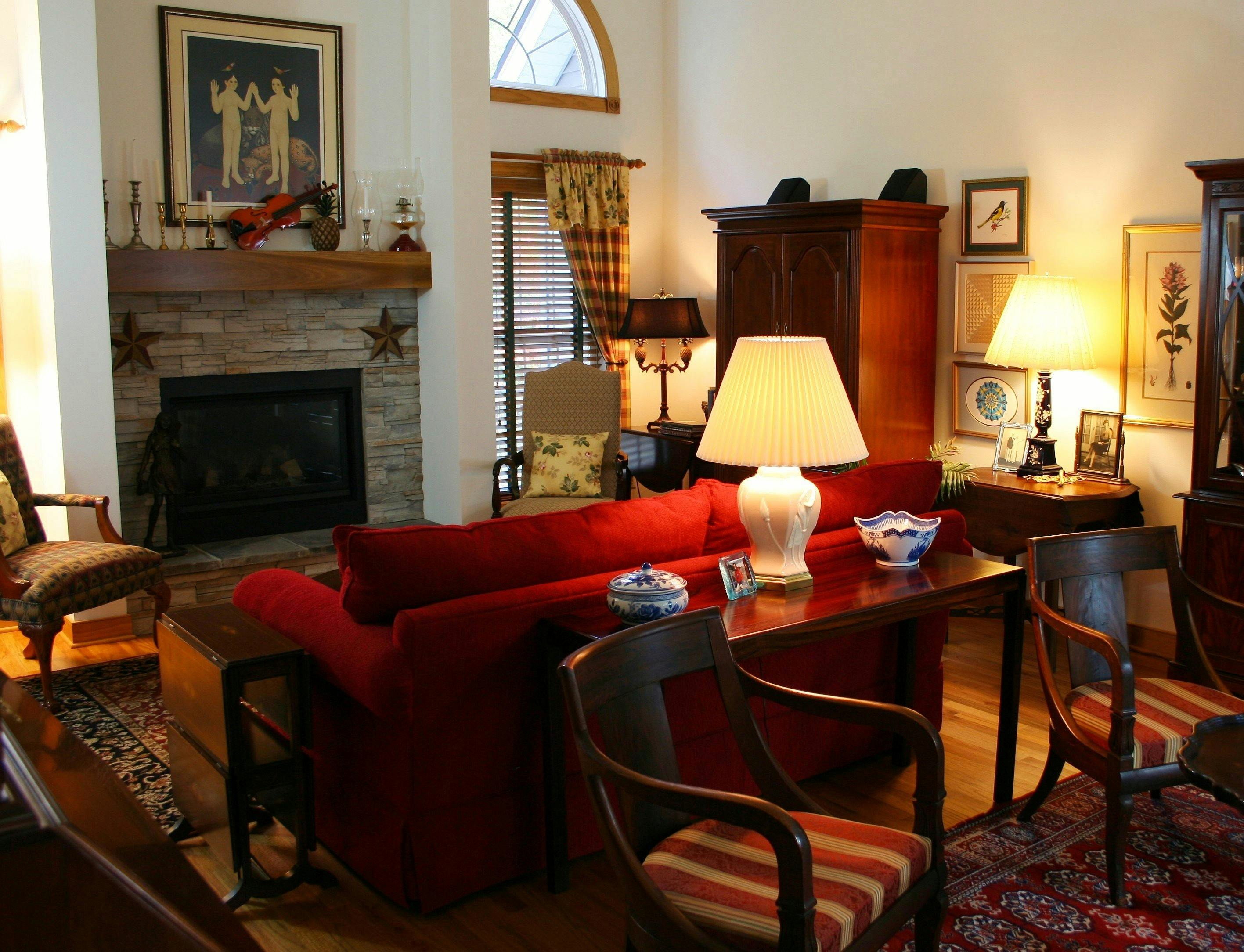 Brown Wooden Console Table Next to Red Loveseat