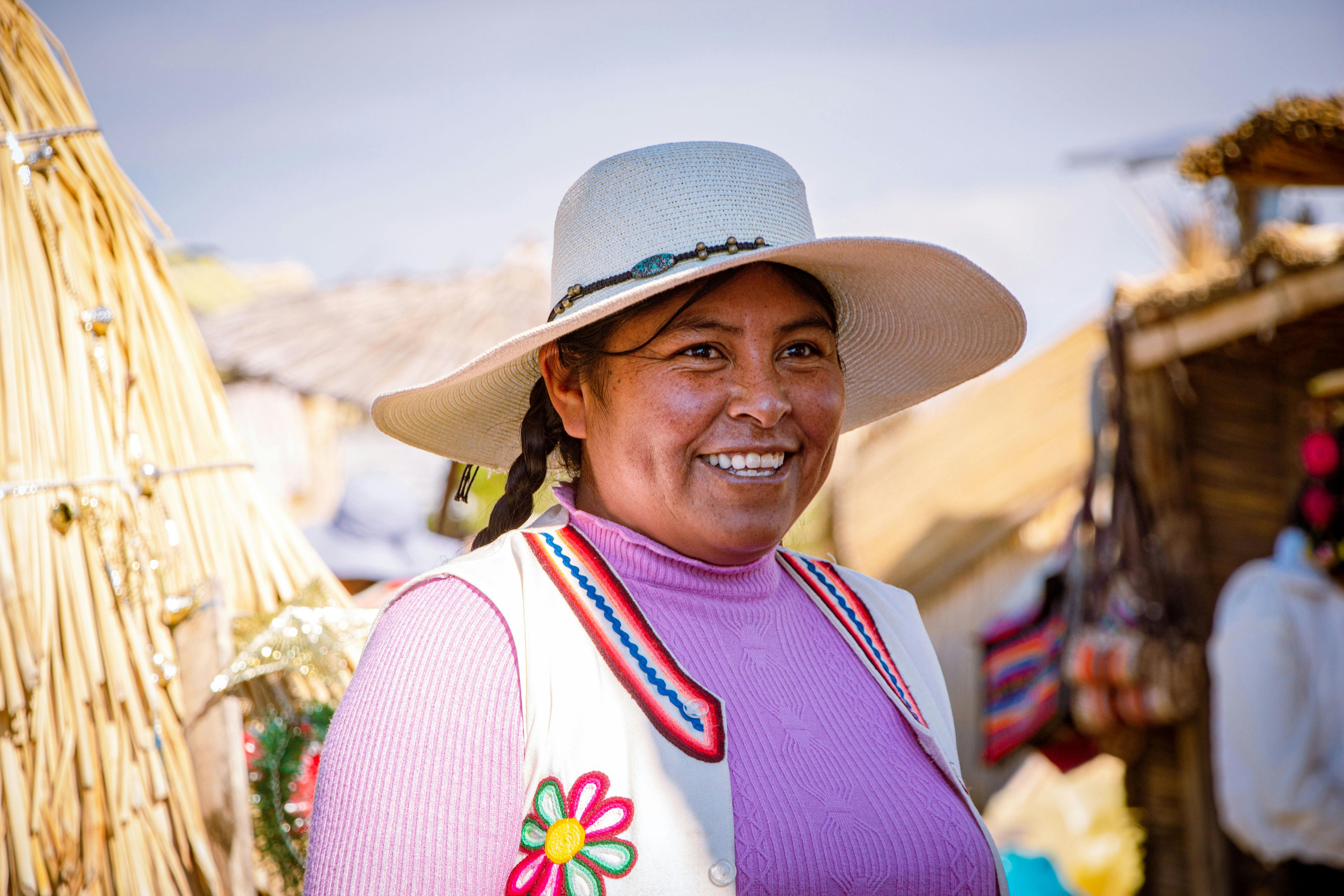 Smiling Woman in White Sun Hat and Embroidered Vest