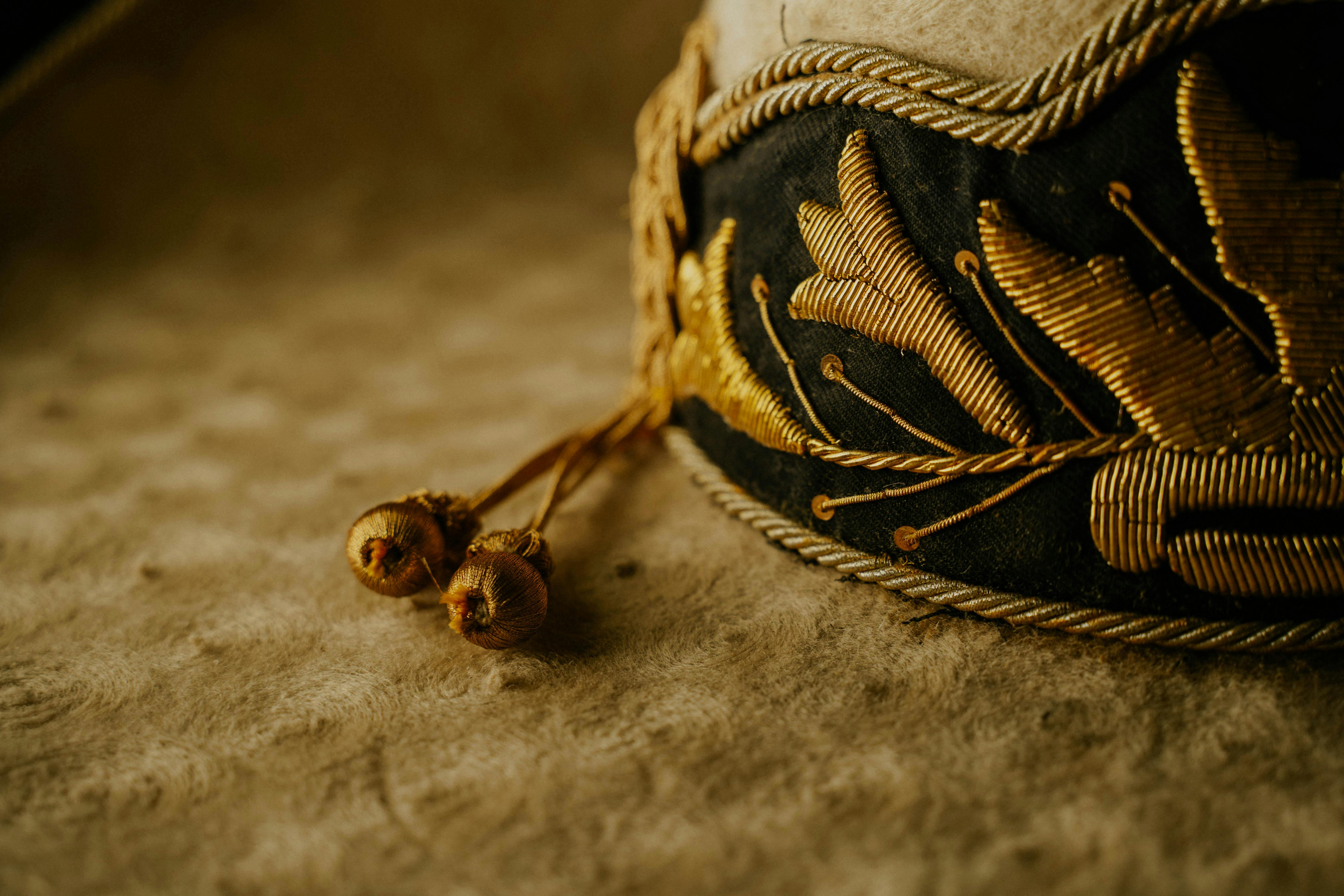 A close up of a gold and black hat