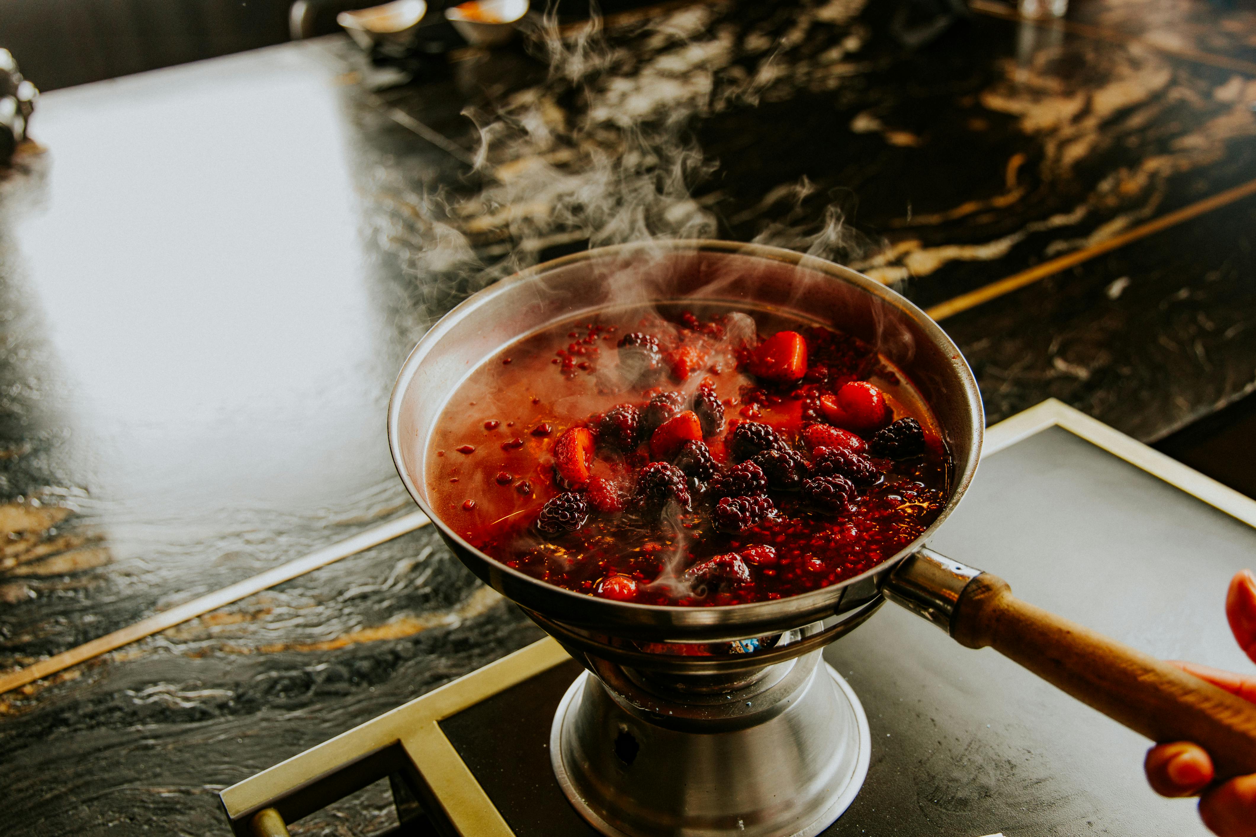 Hand of a Cook Preparing a Jam
