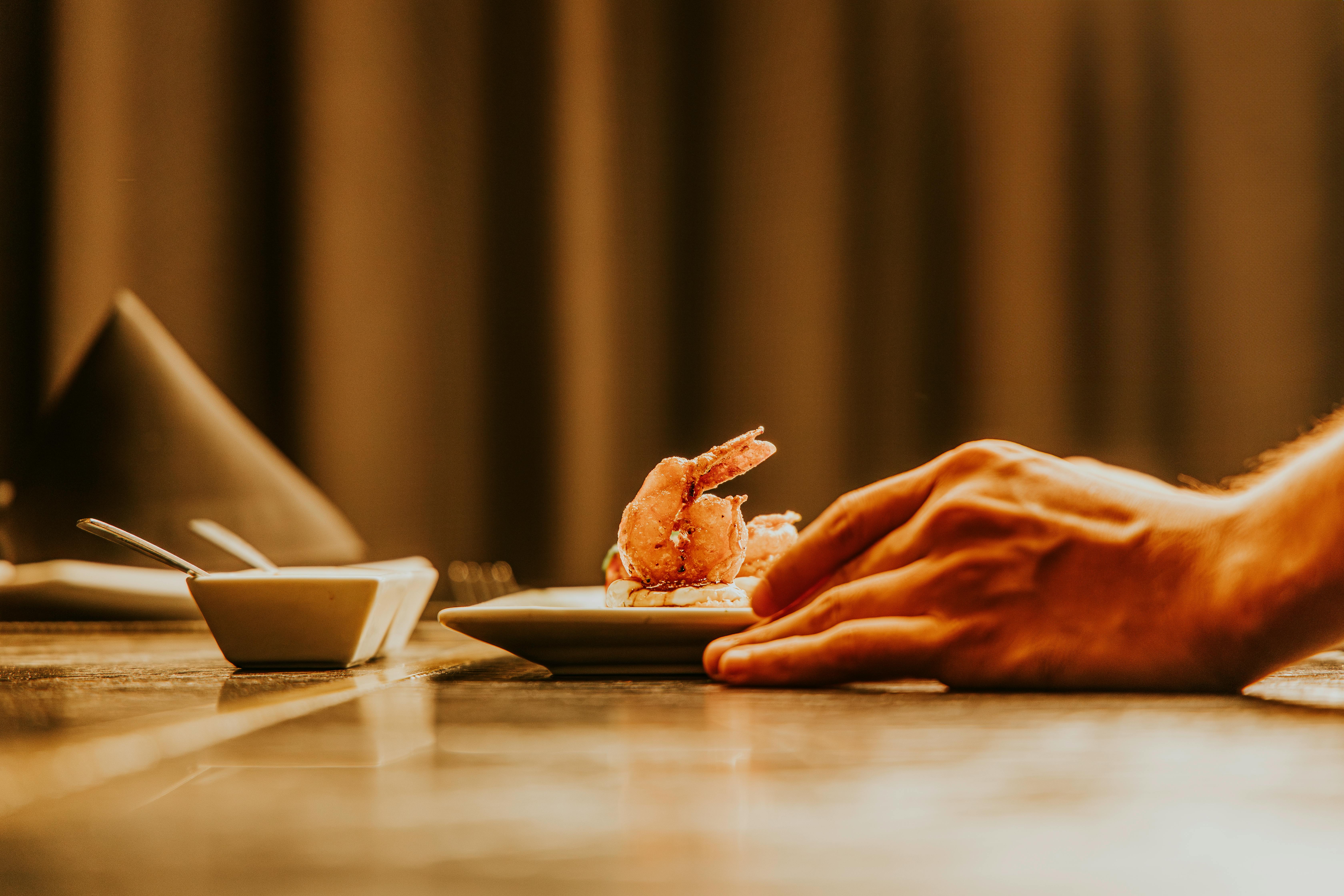 Hand of a Cook Preparing a Dish