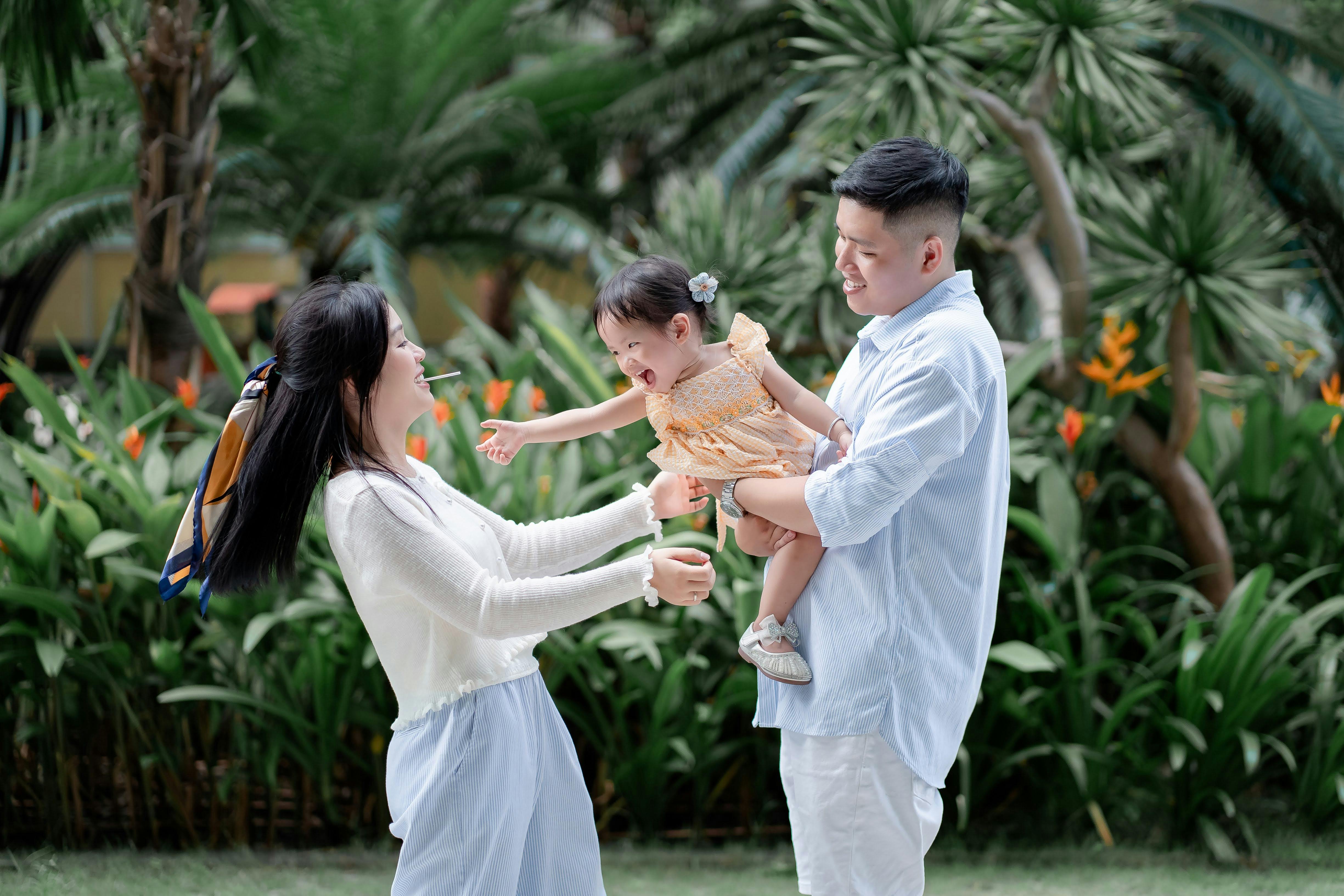 A man and woman holding a child in the air