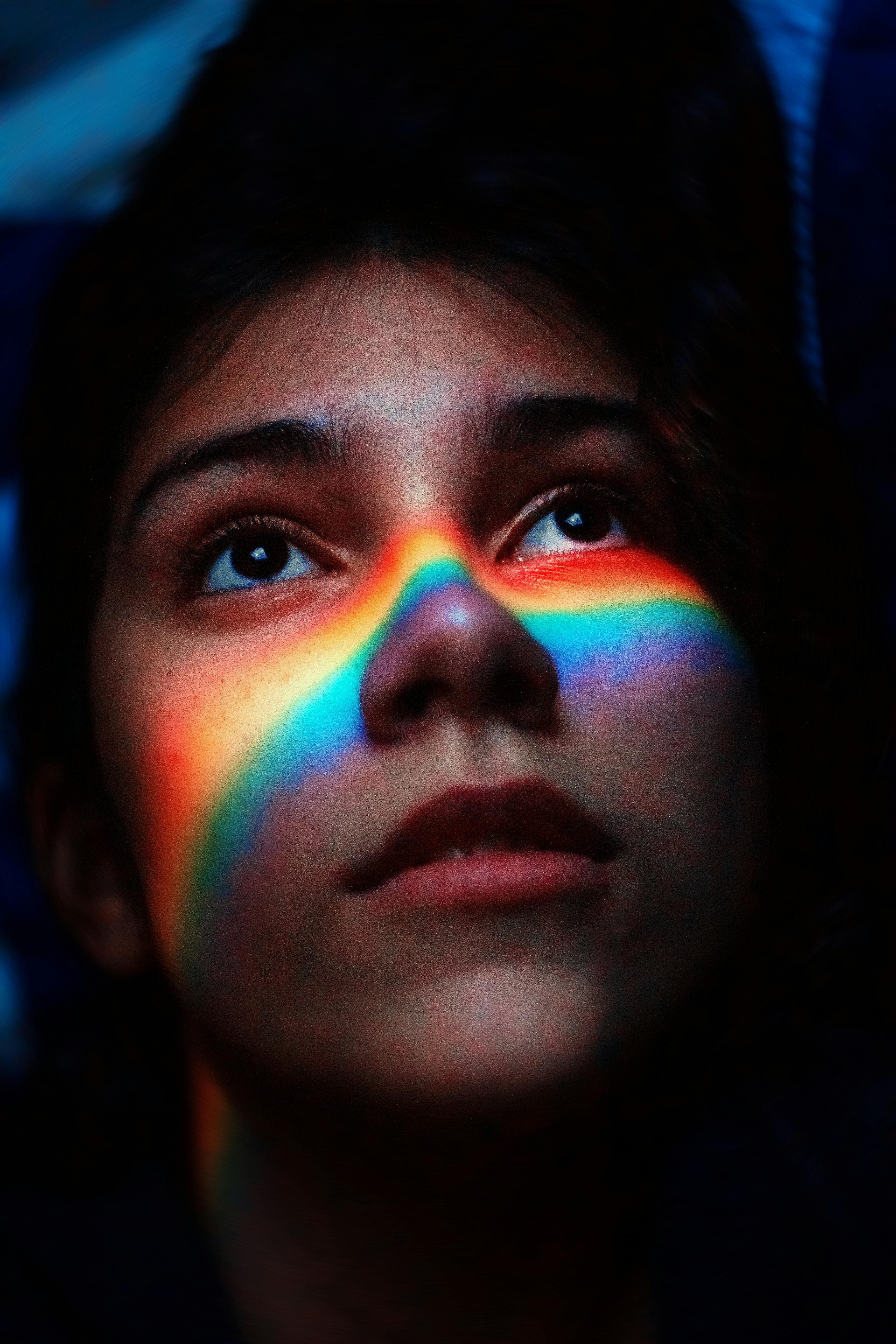 Woman With Rainbow Light Reflecting Her Face