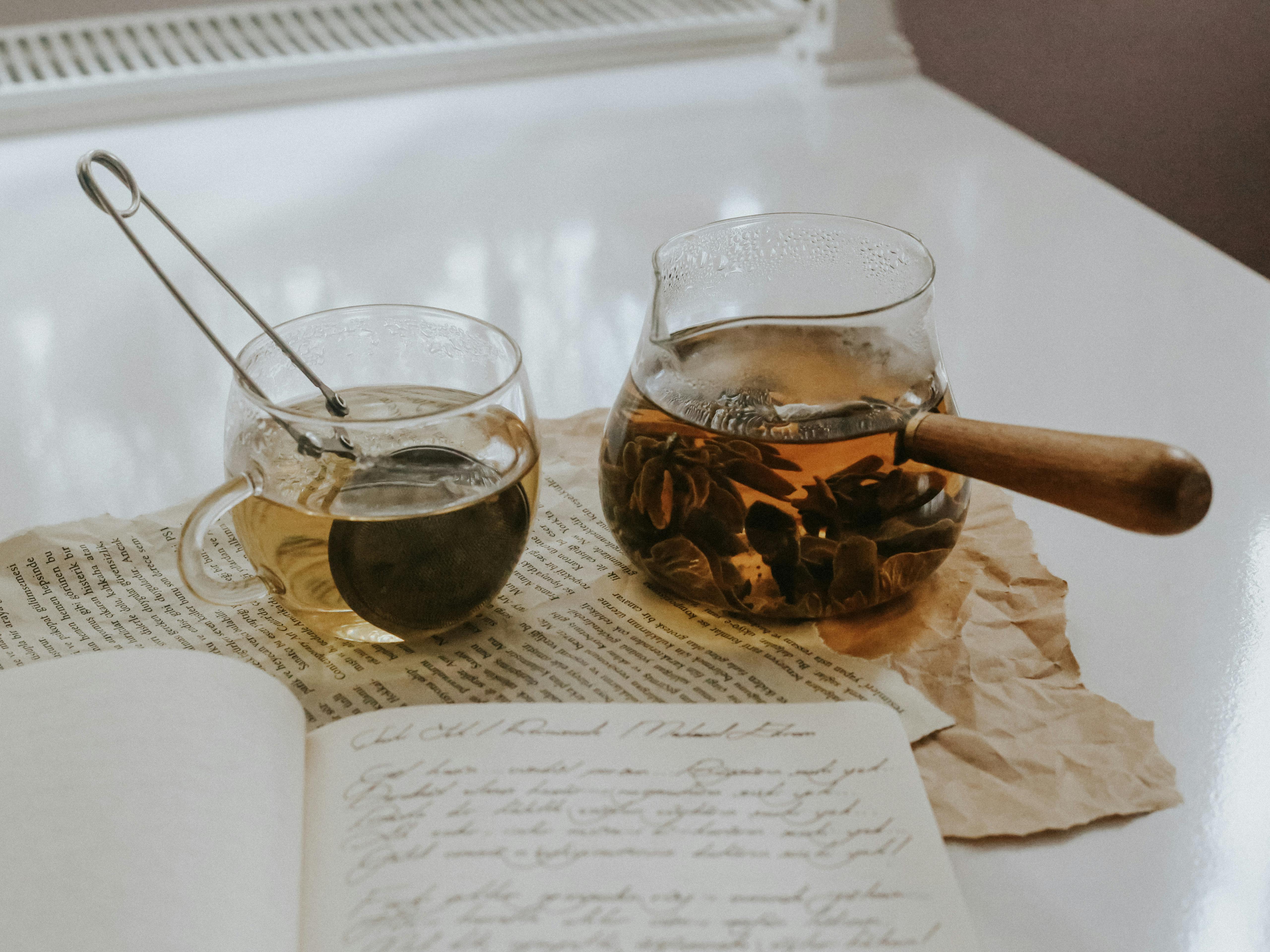 Aesthetic Tea Setup with Glass Teapot and Letters