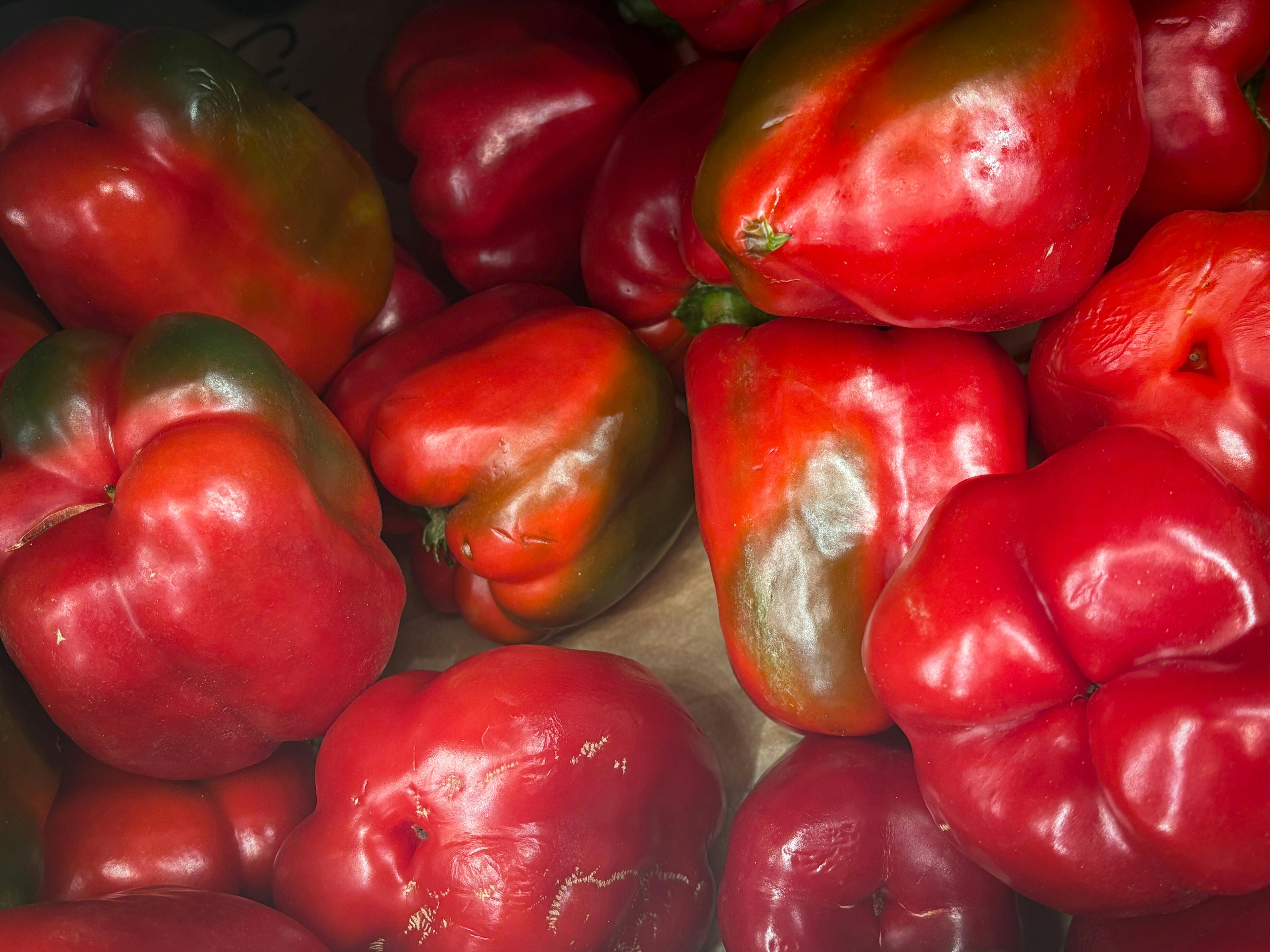 Fresh Red Bell Peppers in Market Display