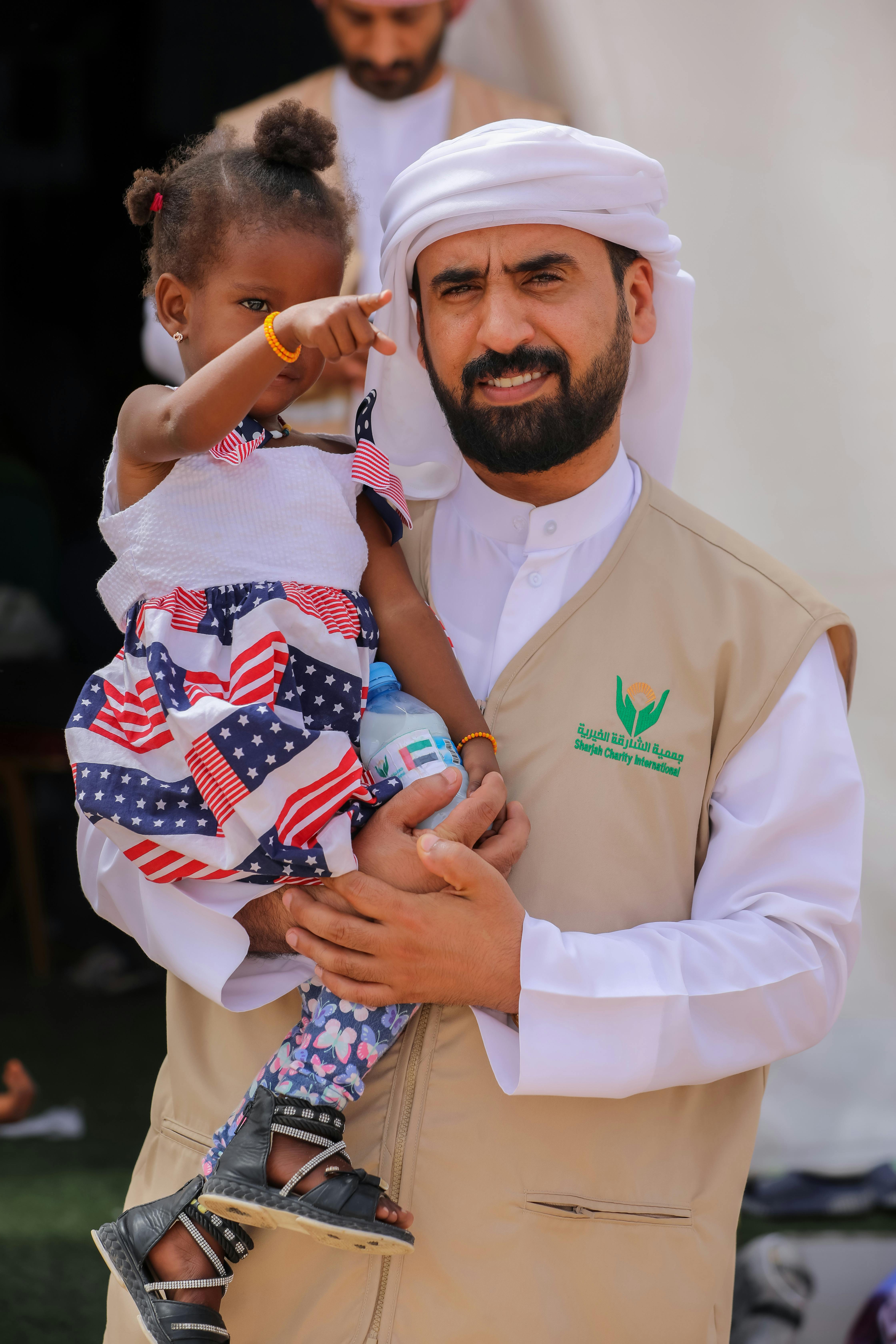 Cultural Exchange: Man Holding Child Outdoors