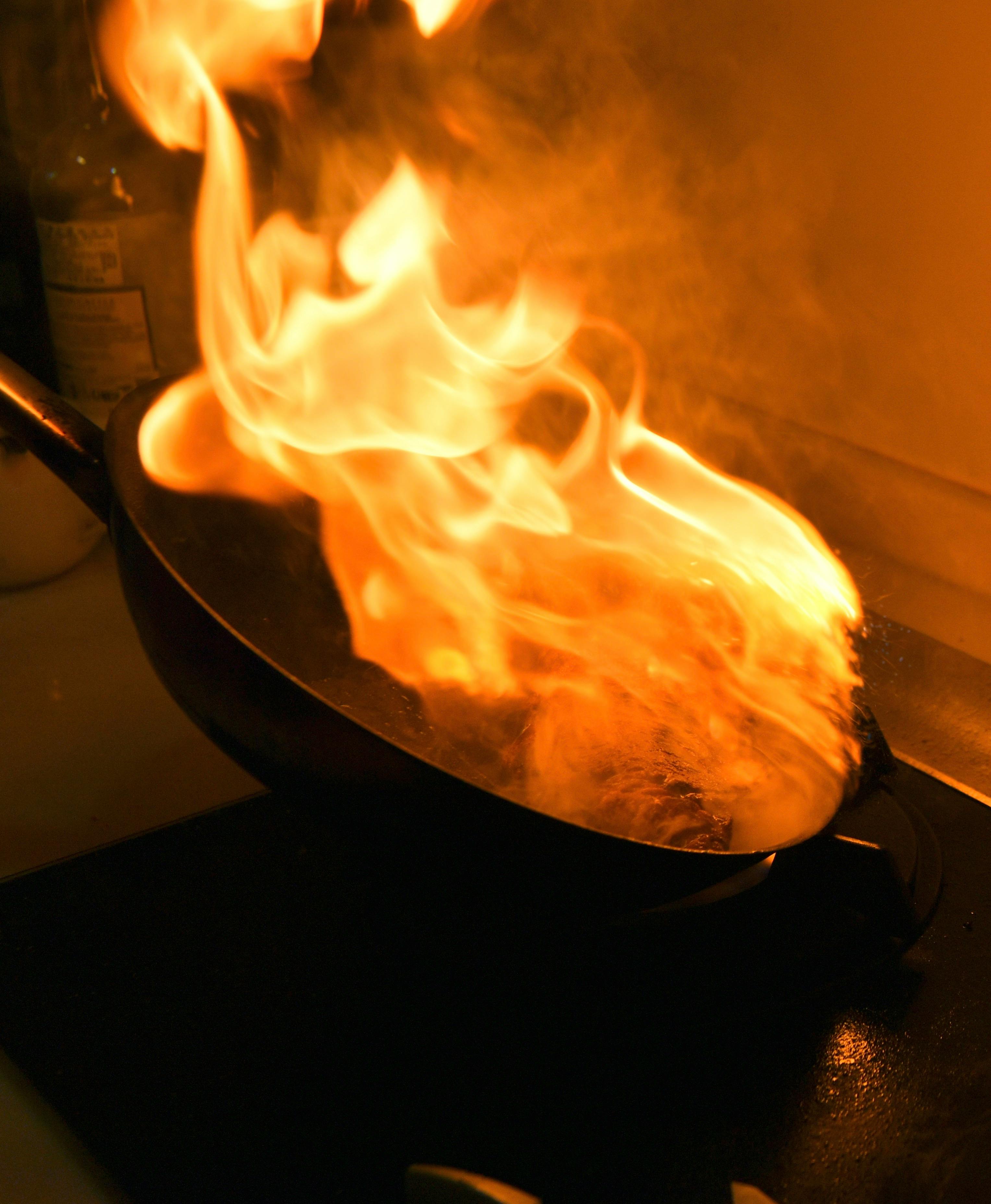 Flaming Wok in Action - Dynamic Cooking Moment