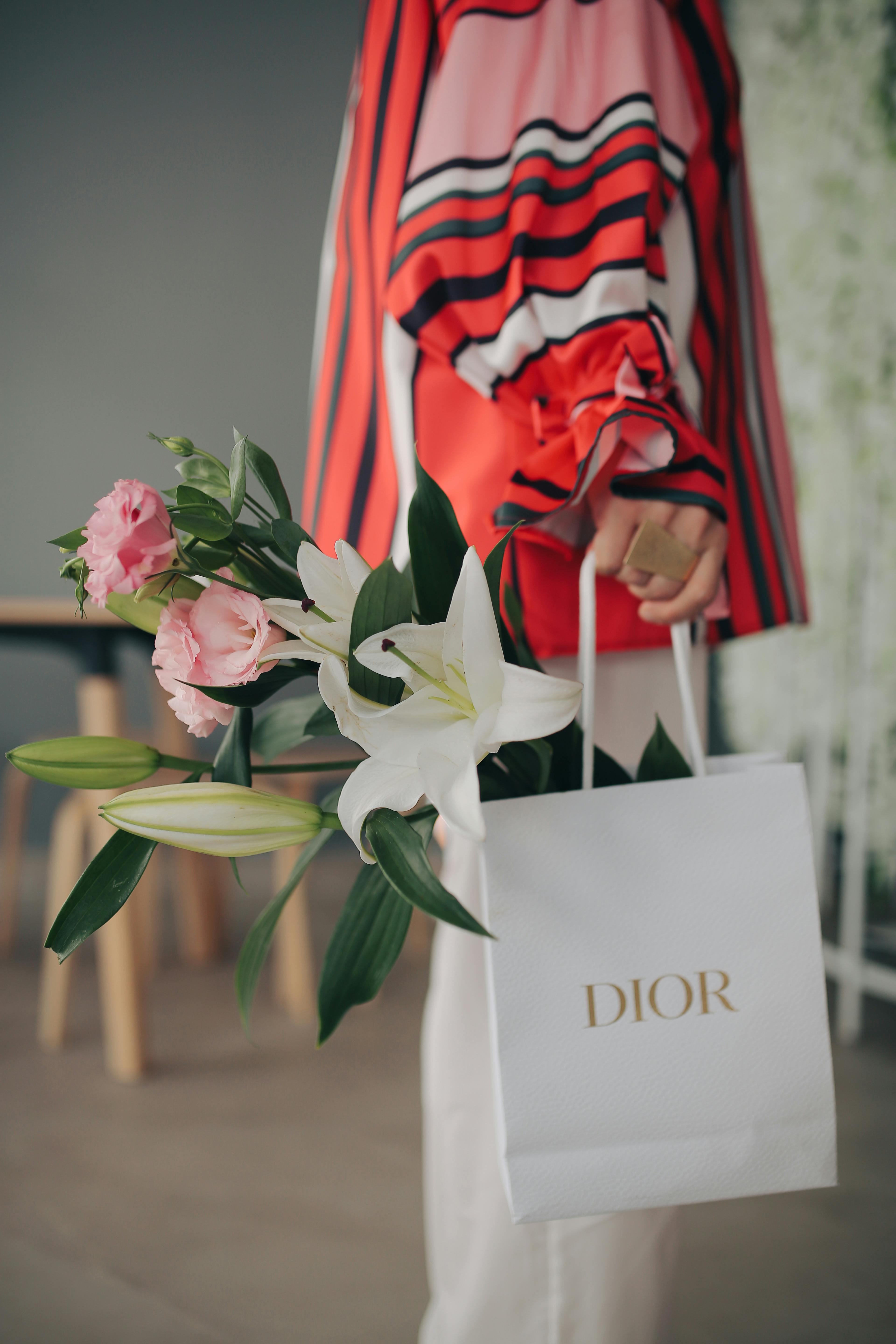 Stylish Woman Holding Dior Bag with Flowers