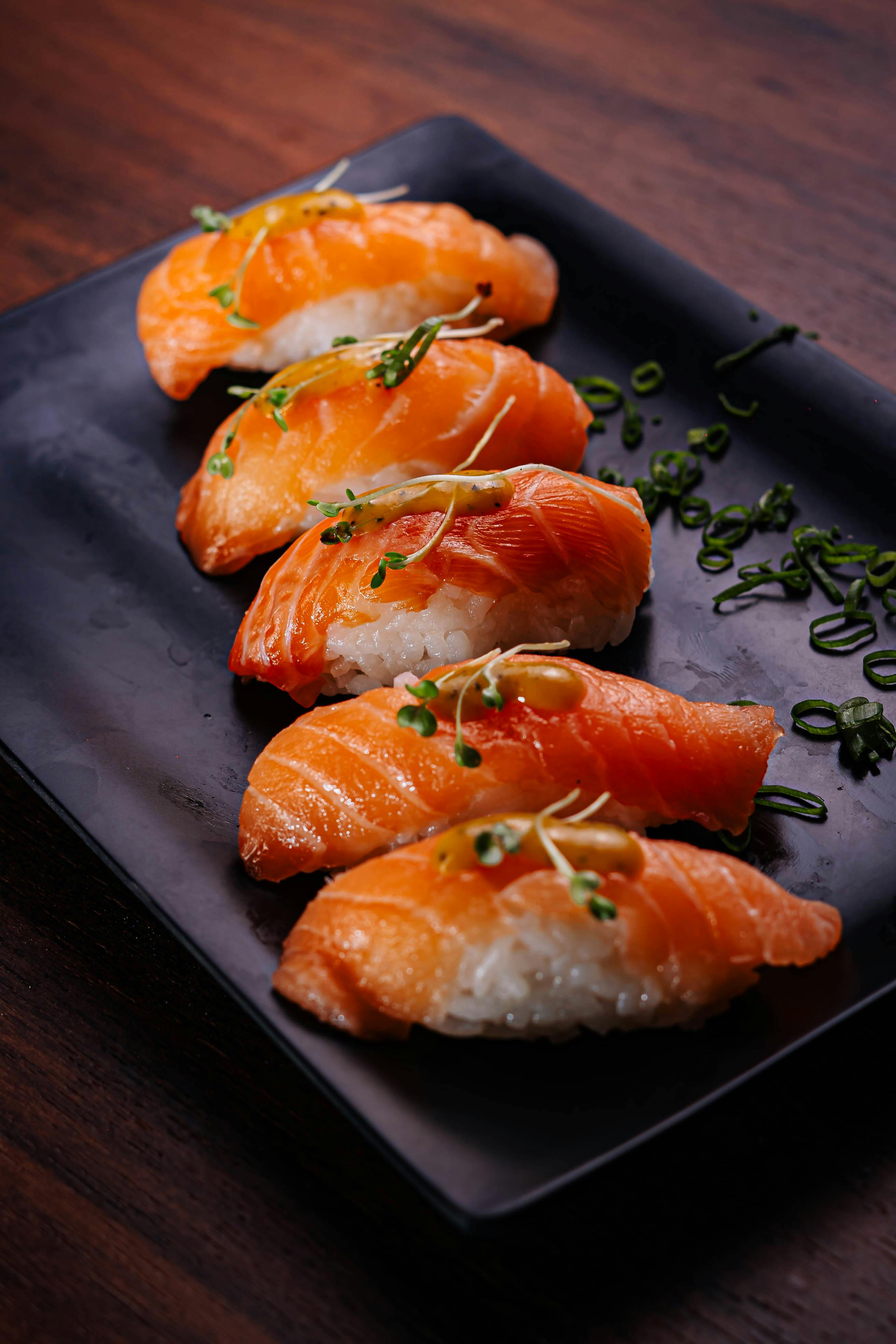 Delicious Salmon Nigiri Sushi on Black Plate