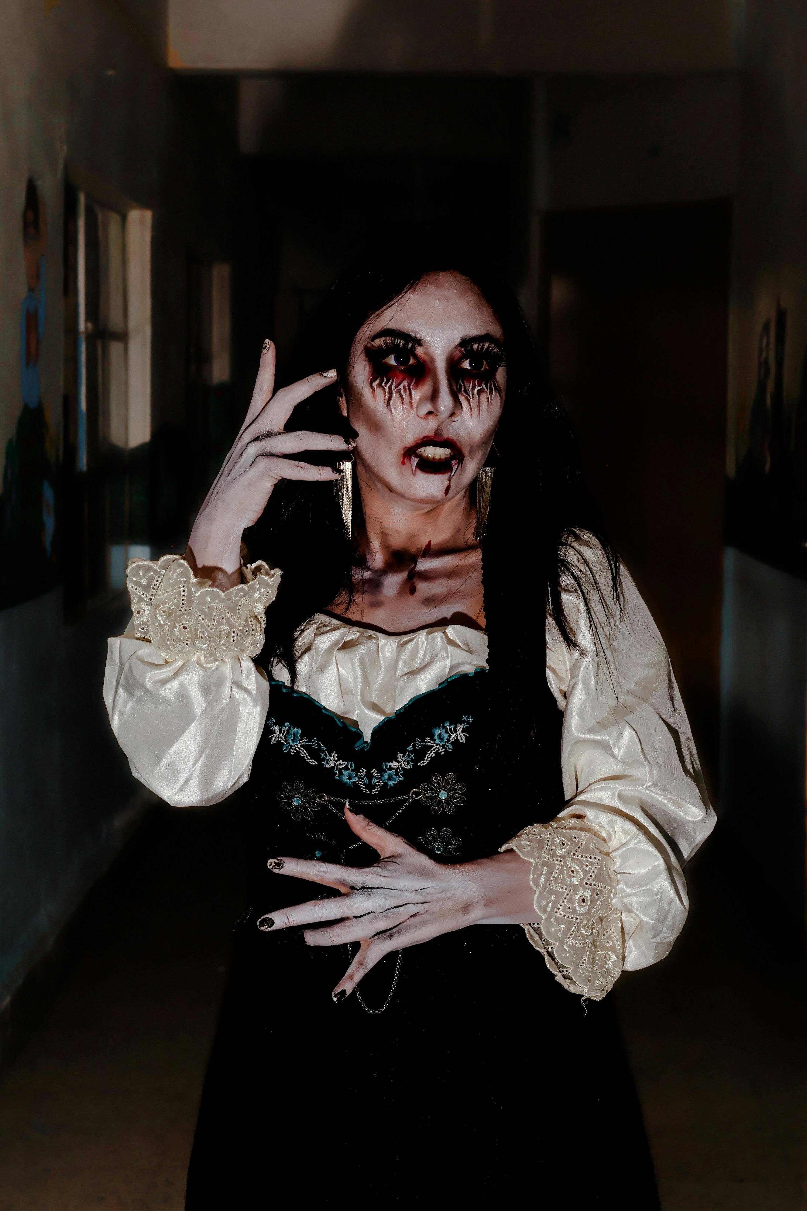 Spooky Woman in Gothic Costume in Dark Hallway