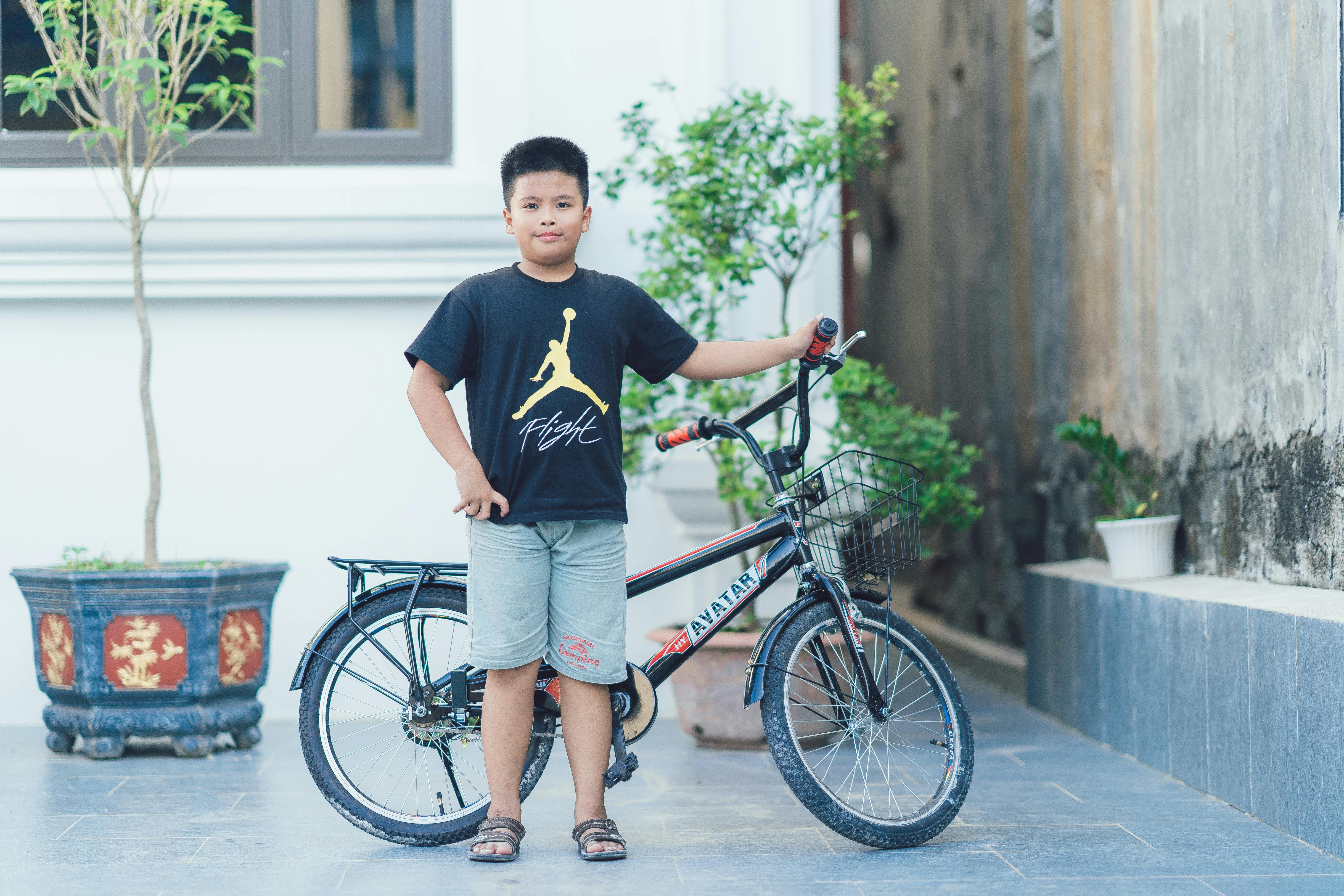 Young Boy With Bicycle in Urban Setting