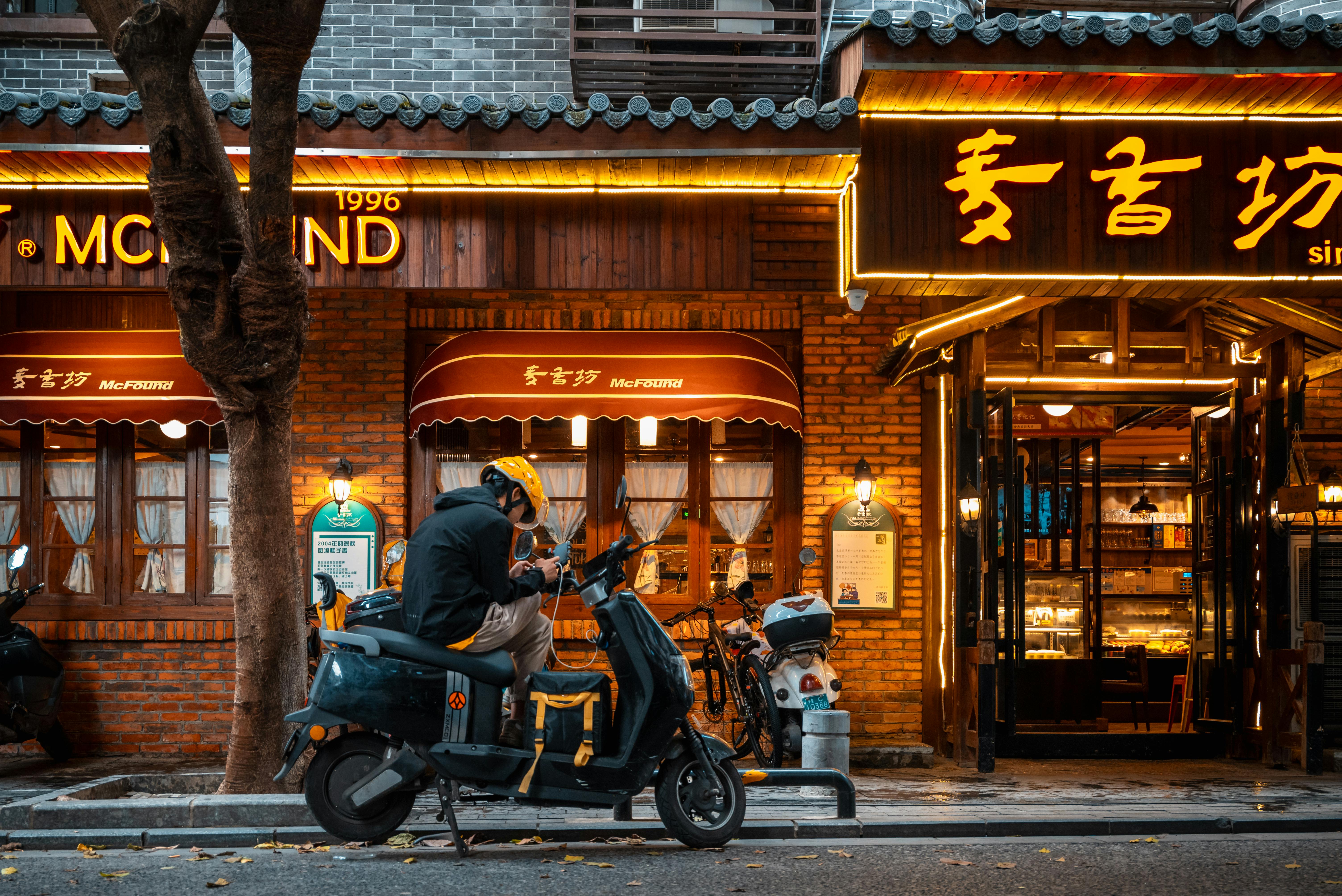 Urban Scooter Delivery at Night in City