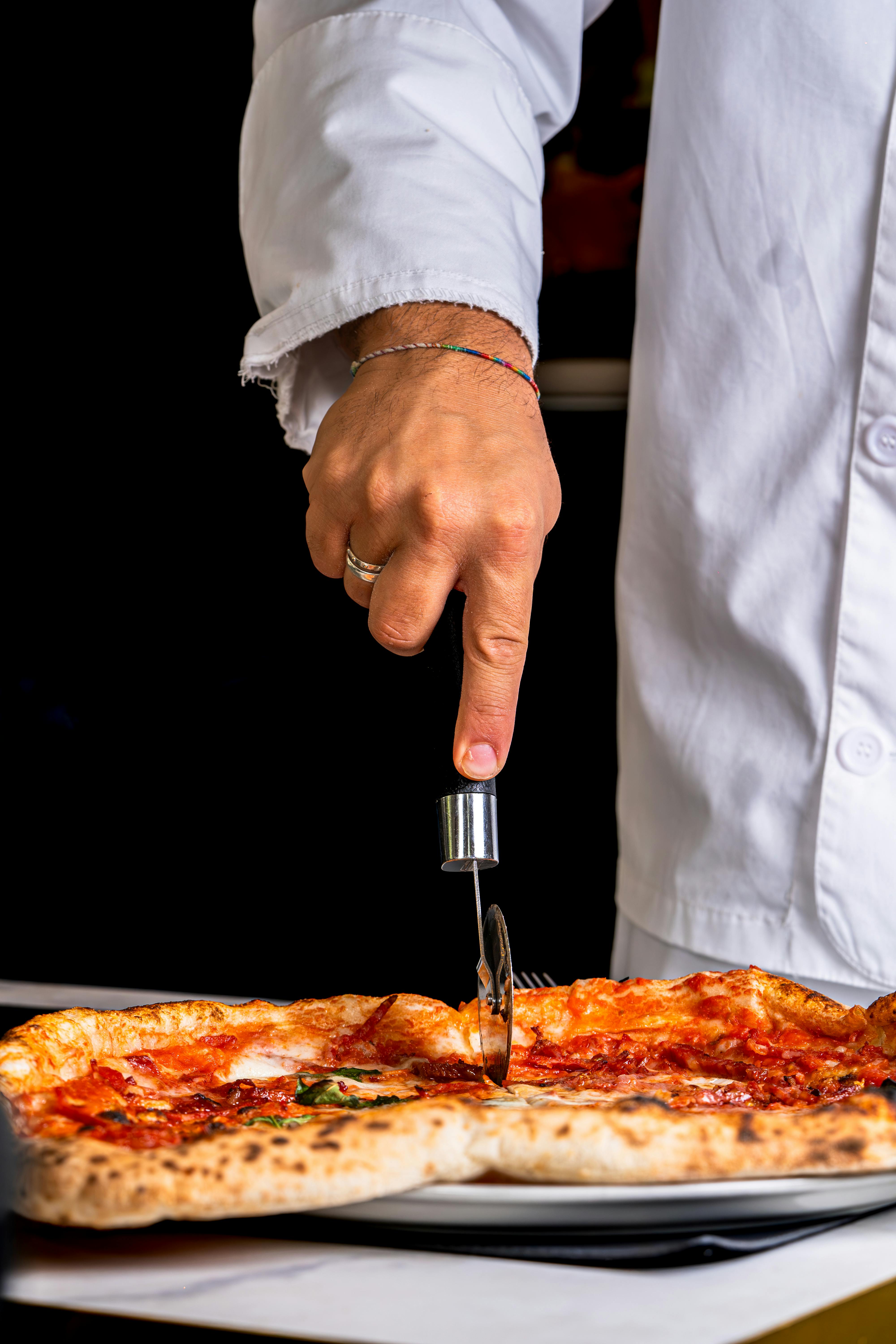 Chef Slicing Freshly Baked Pizza