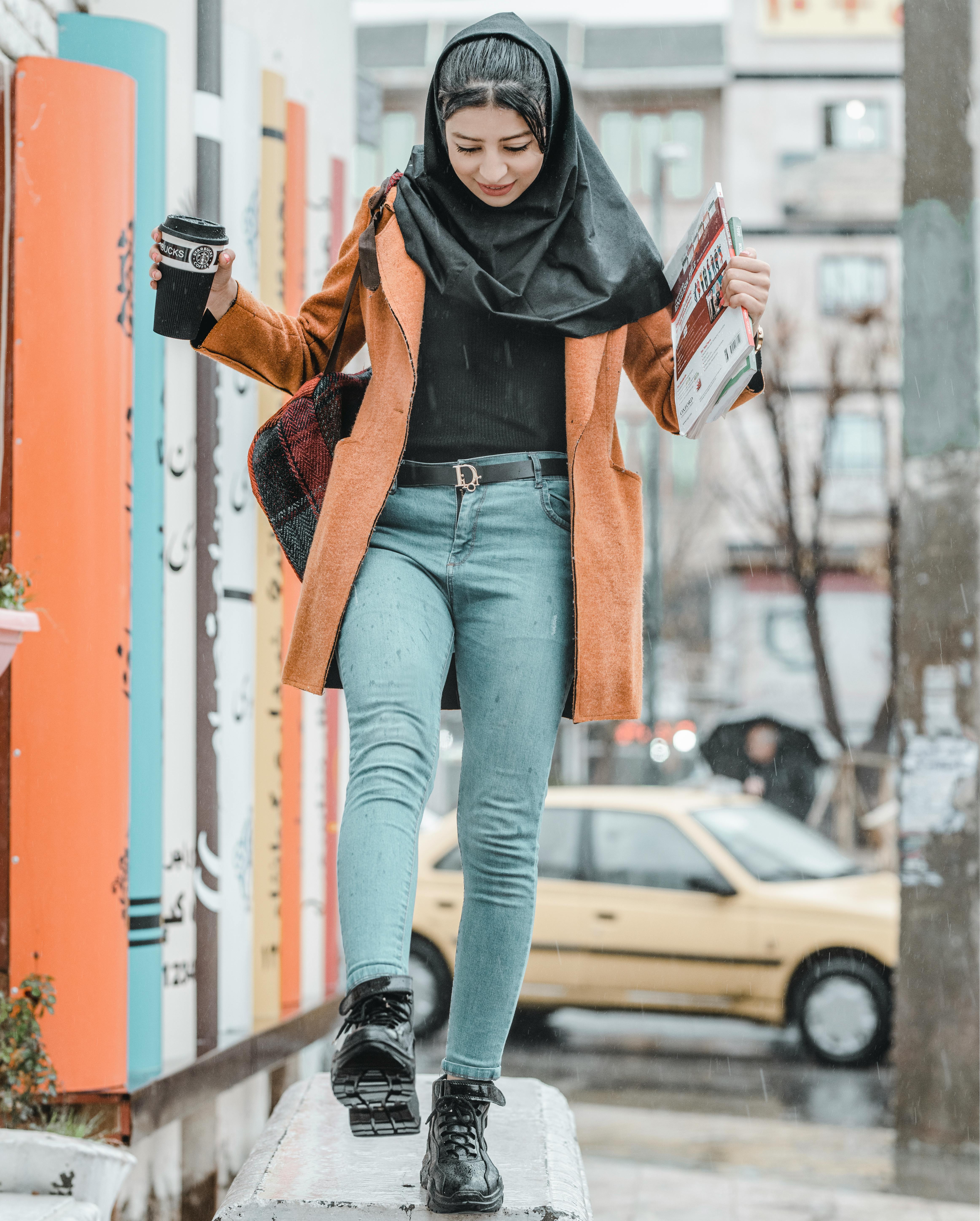 Woman Wearing Brown Coat and Blue Denim Fitted Jeans