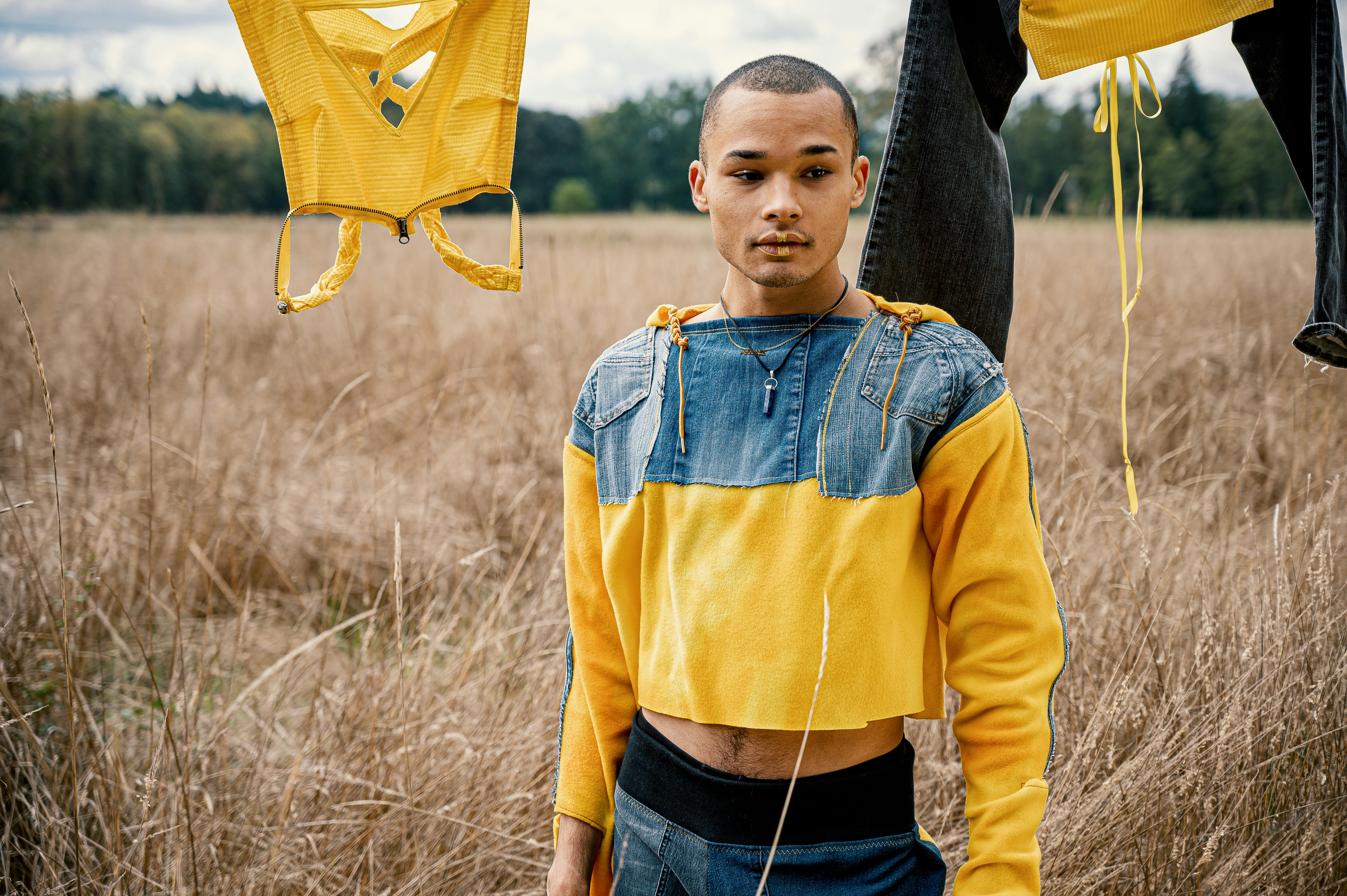 Man in Yellow and Blue Jacket Standing Outdoors