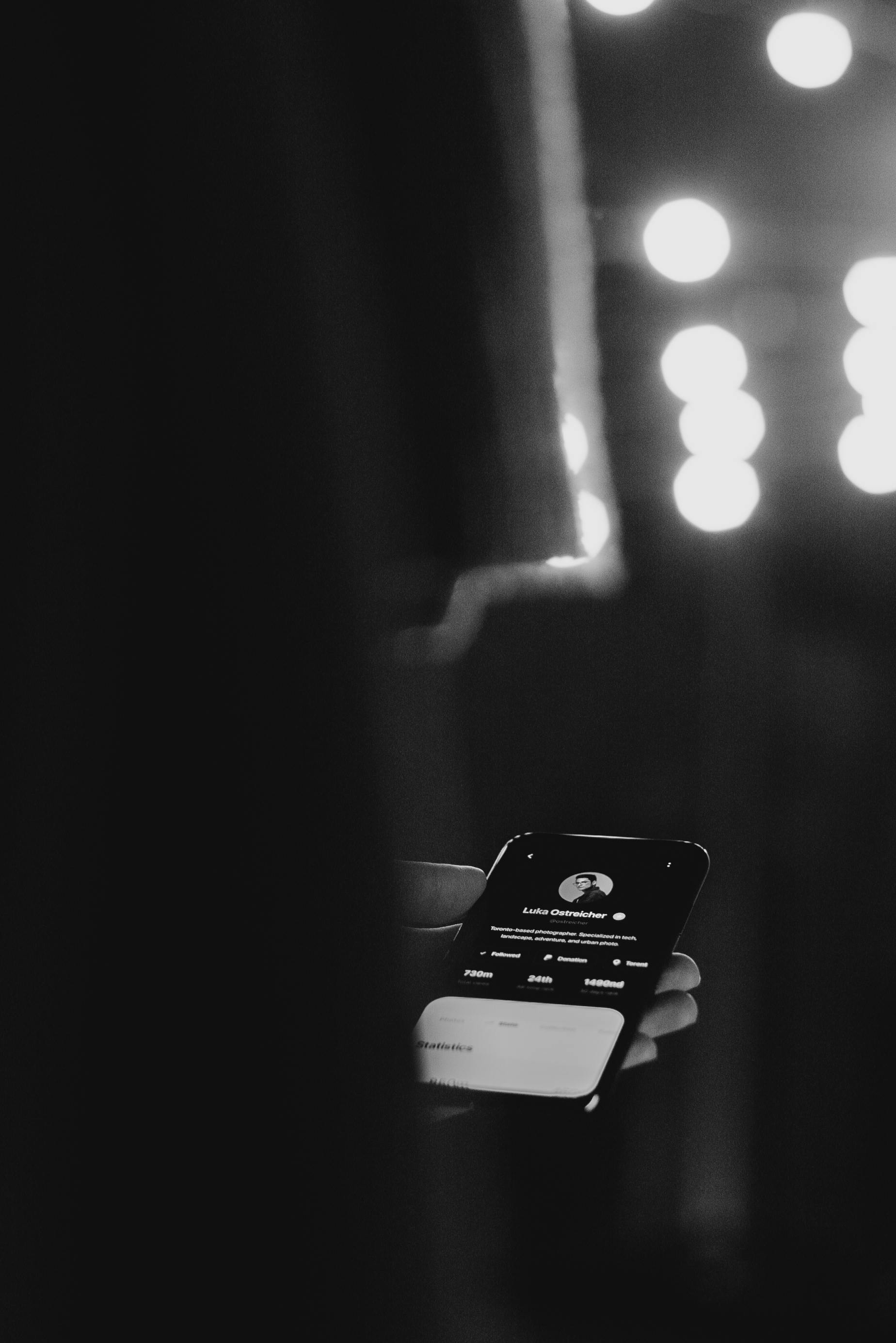 Monochrome Photo of Person Holding Smartphone