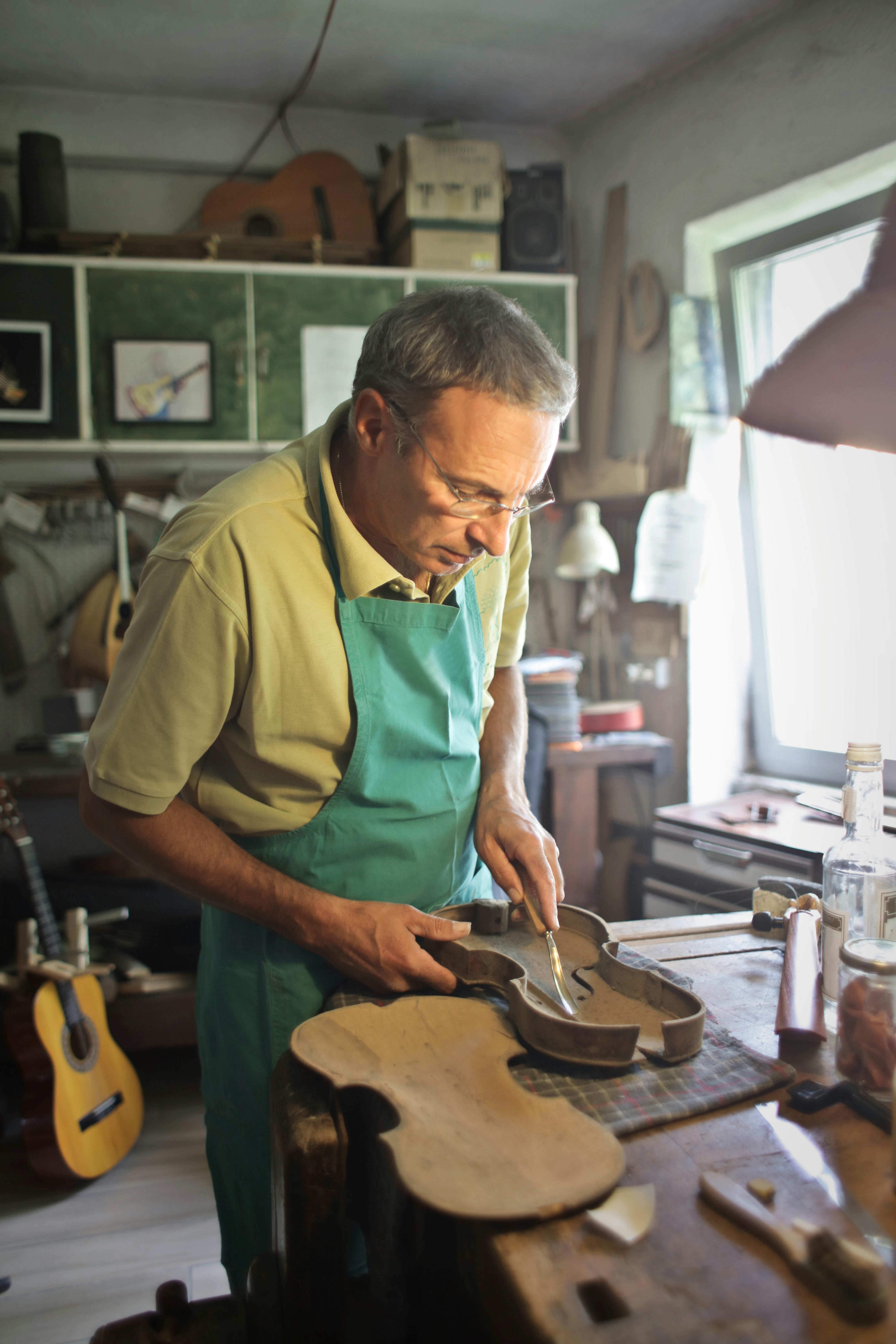 Photo of Man Standing by the Work Table