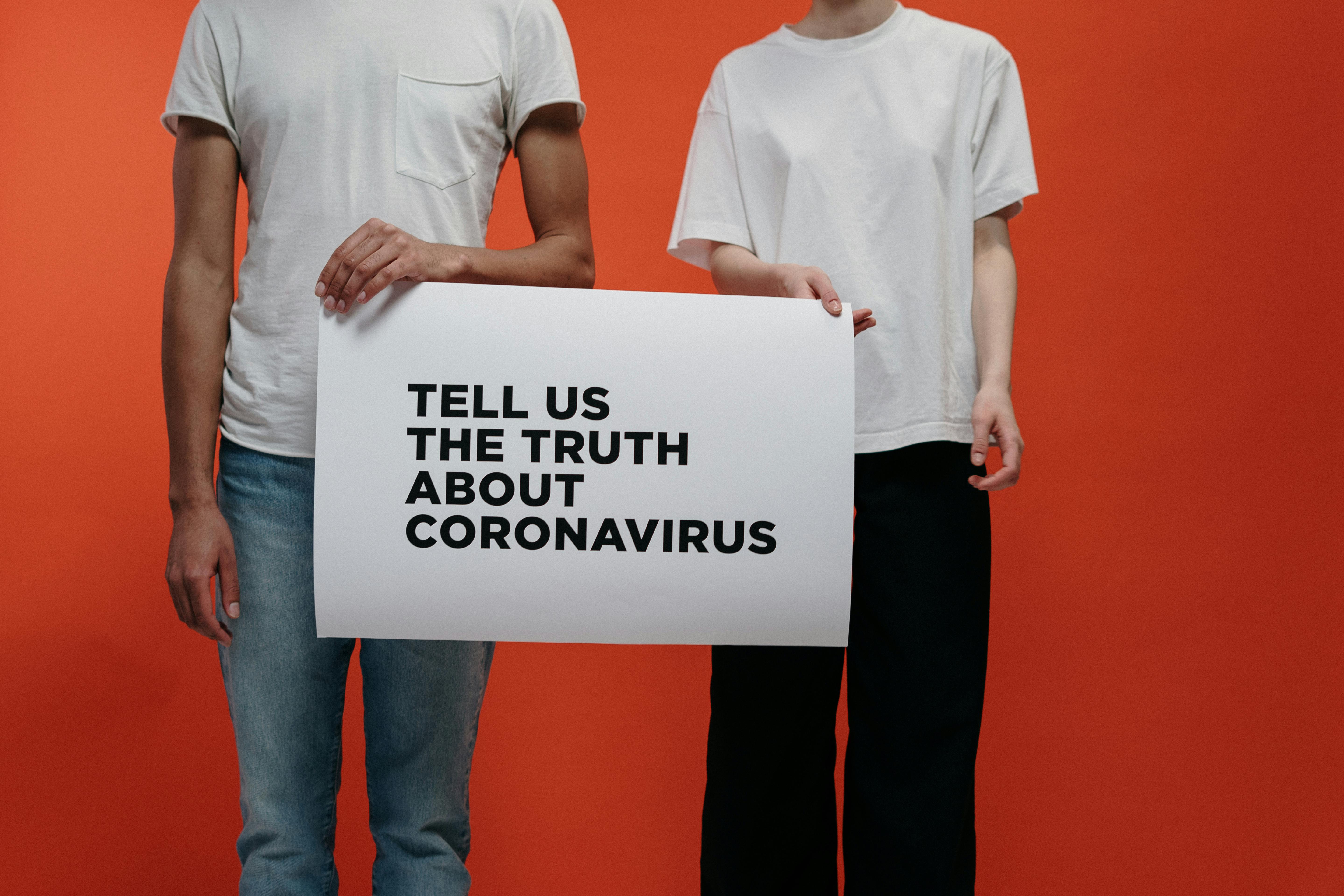 People Holding A Poster Asking About Facts On Coronavirus