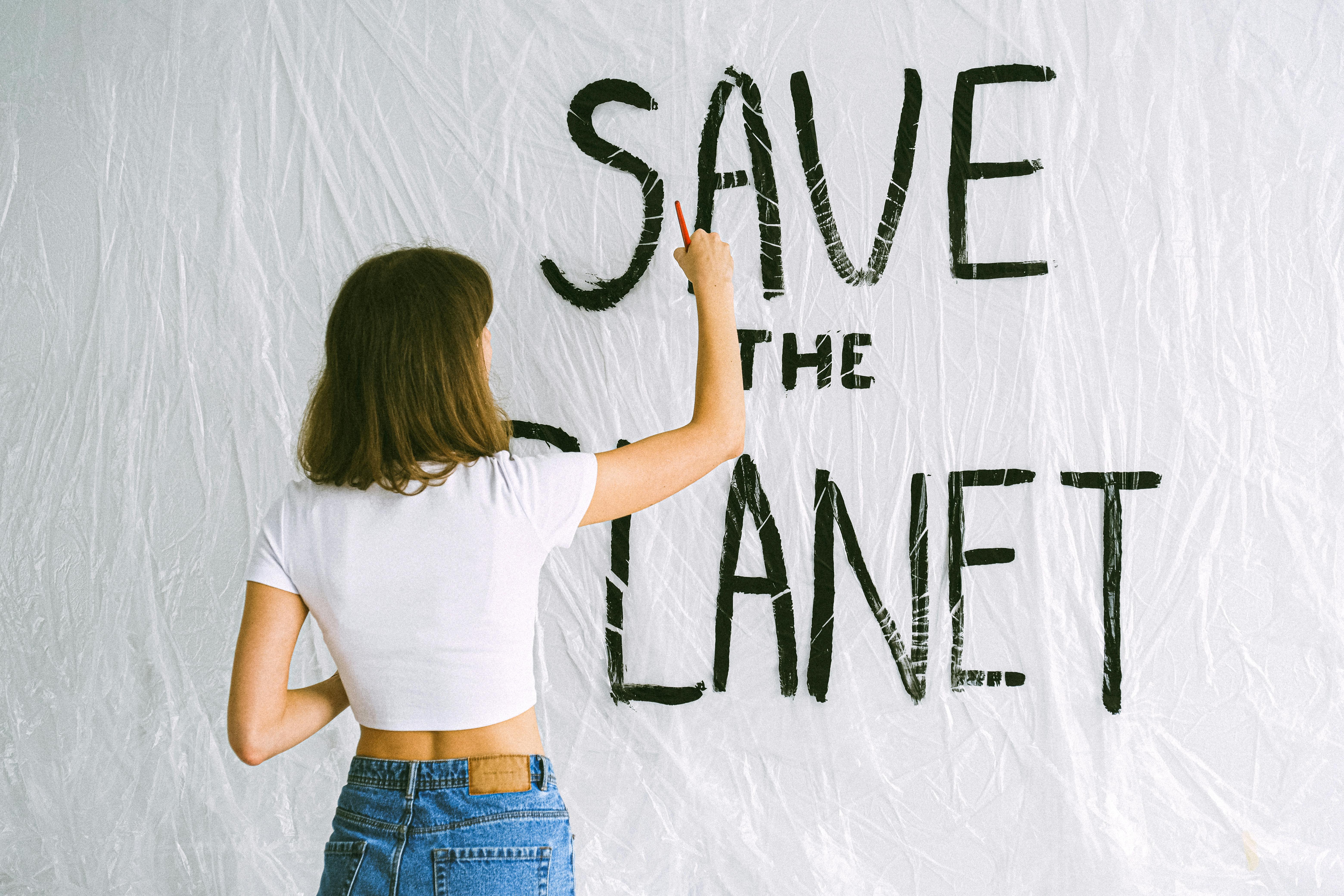 Woman Painting Save The Planet Sign