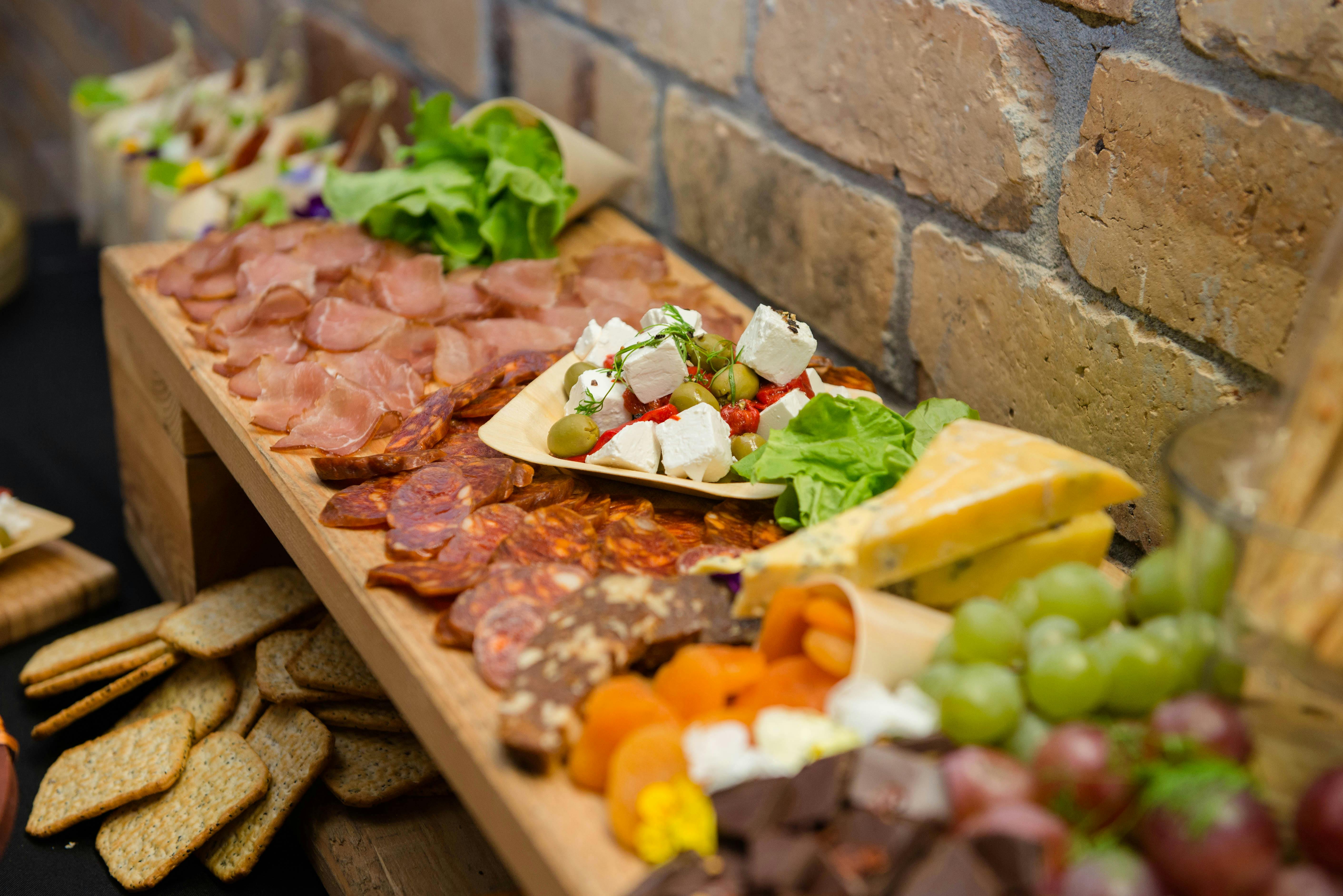 Buffet with various sausages and cheese on sideboard