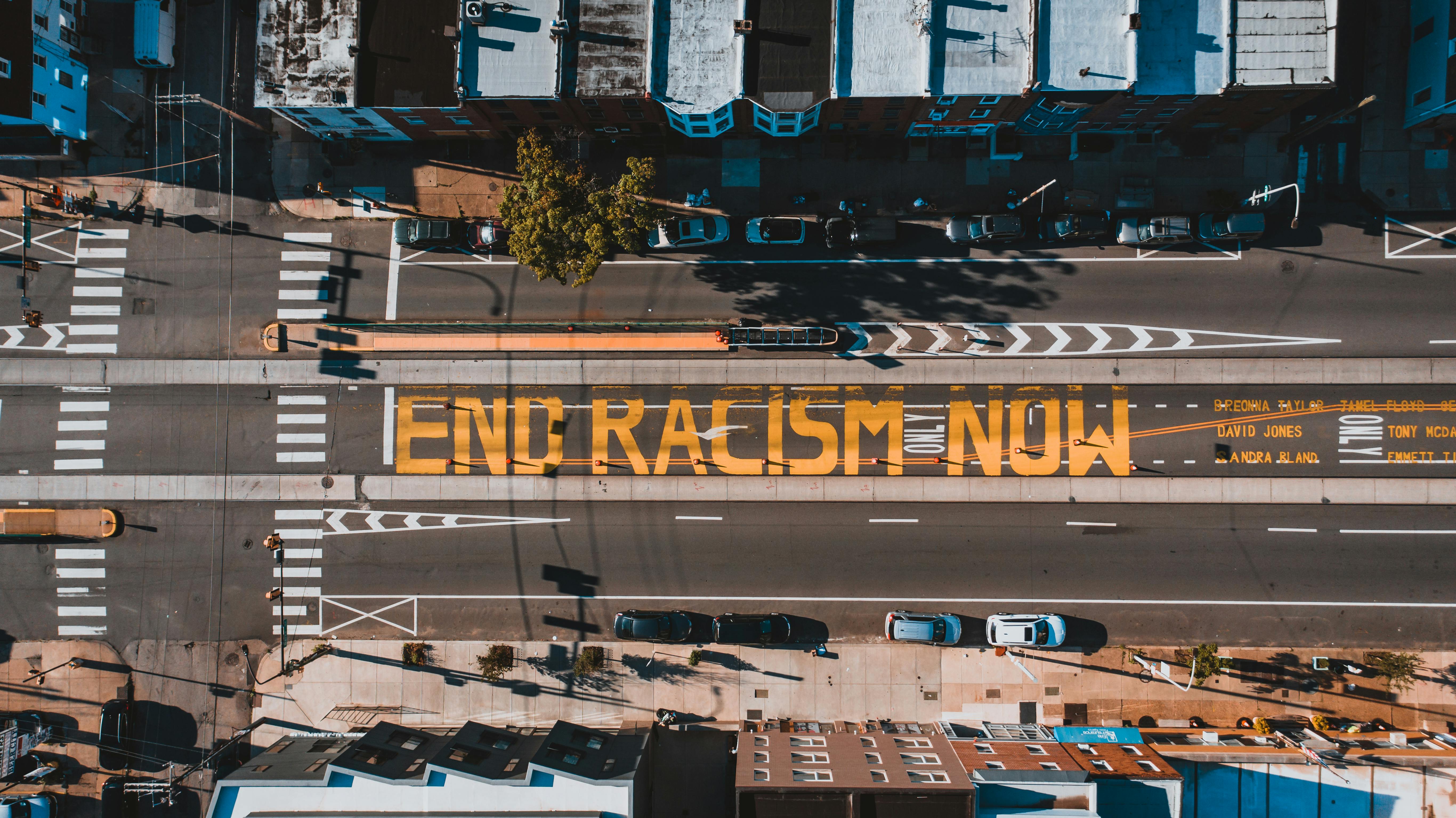 Roadway with END RACISM NOW title in town