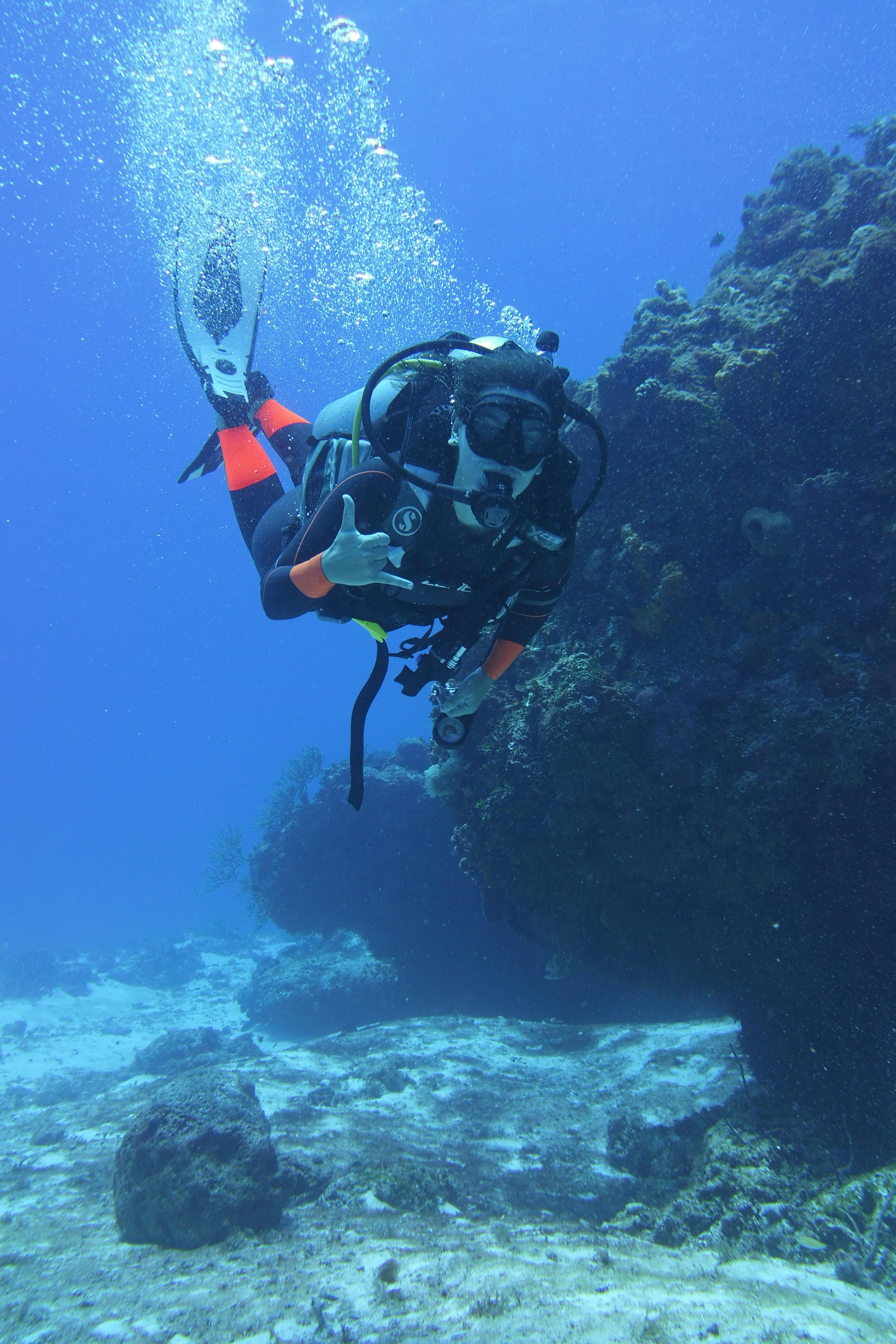 Person Scuba Diving in Blue Water 