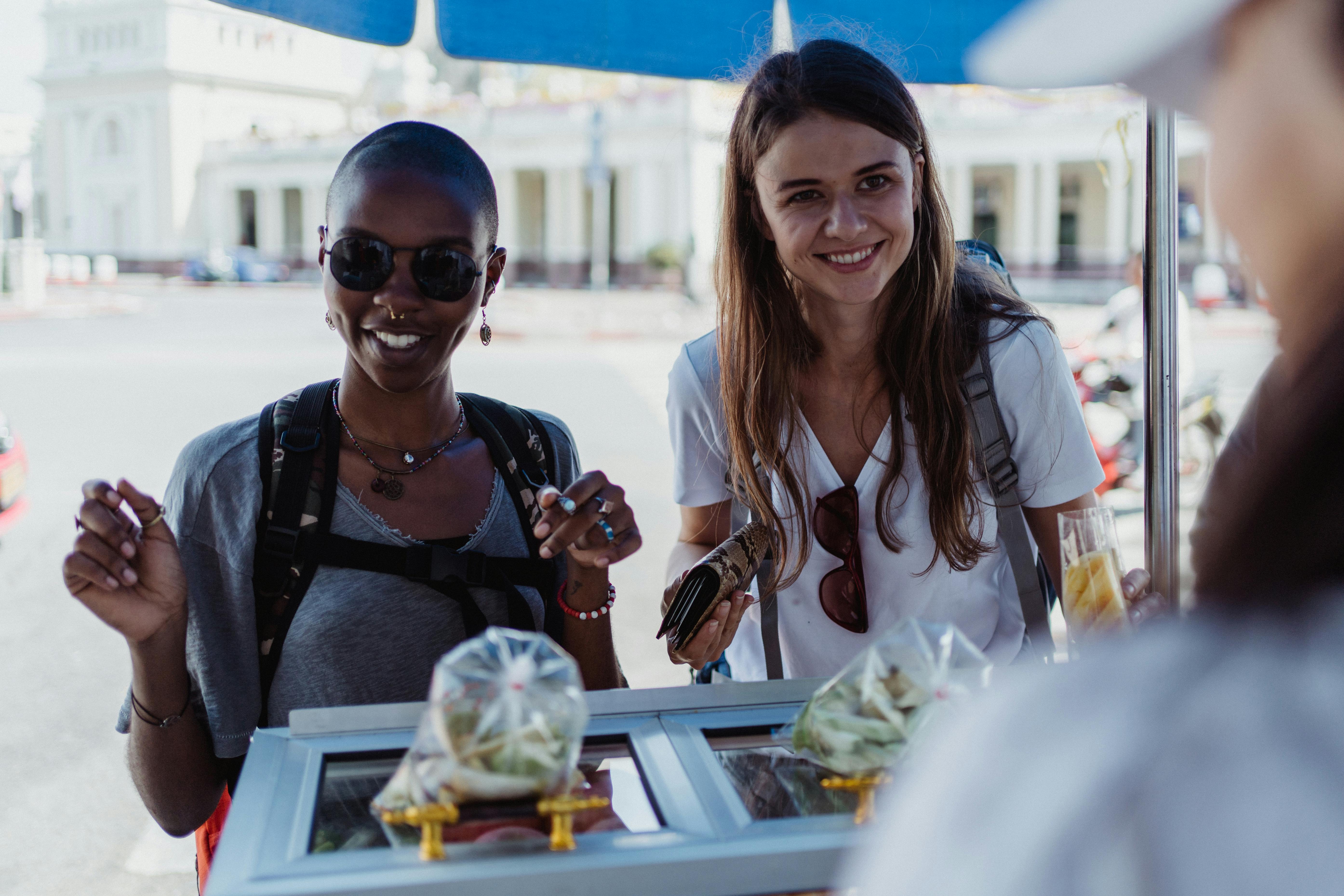 Smiling Women Buying Street Food