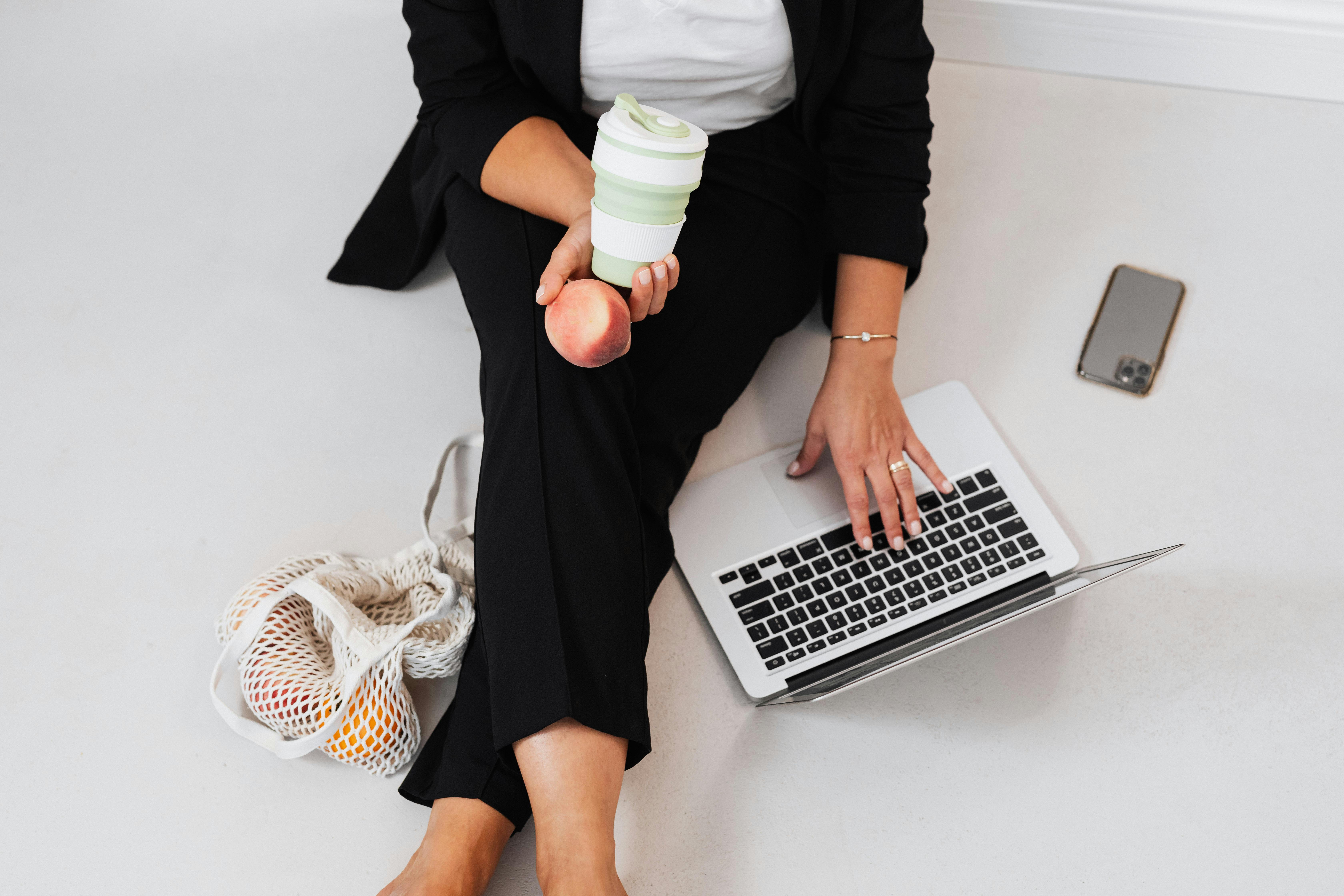A Person Sitting on a Floor Working on Her Laptop
