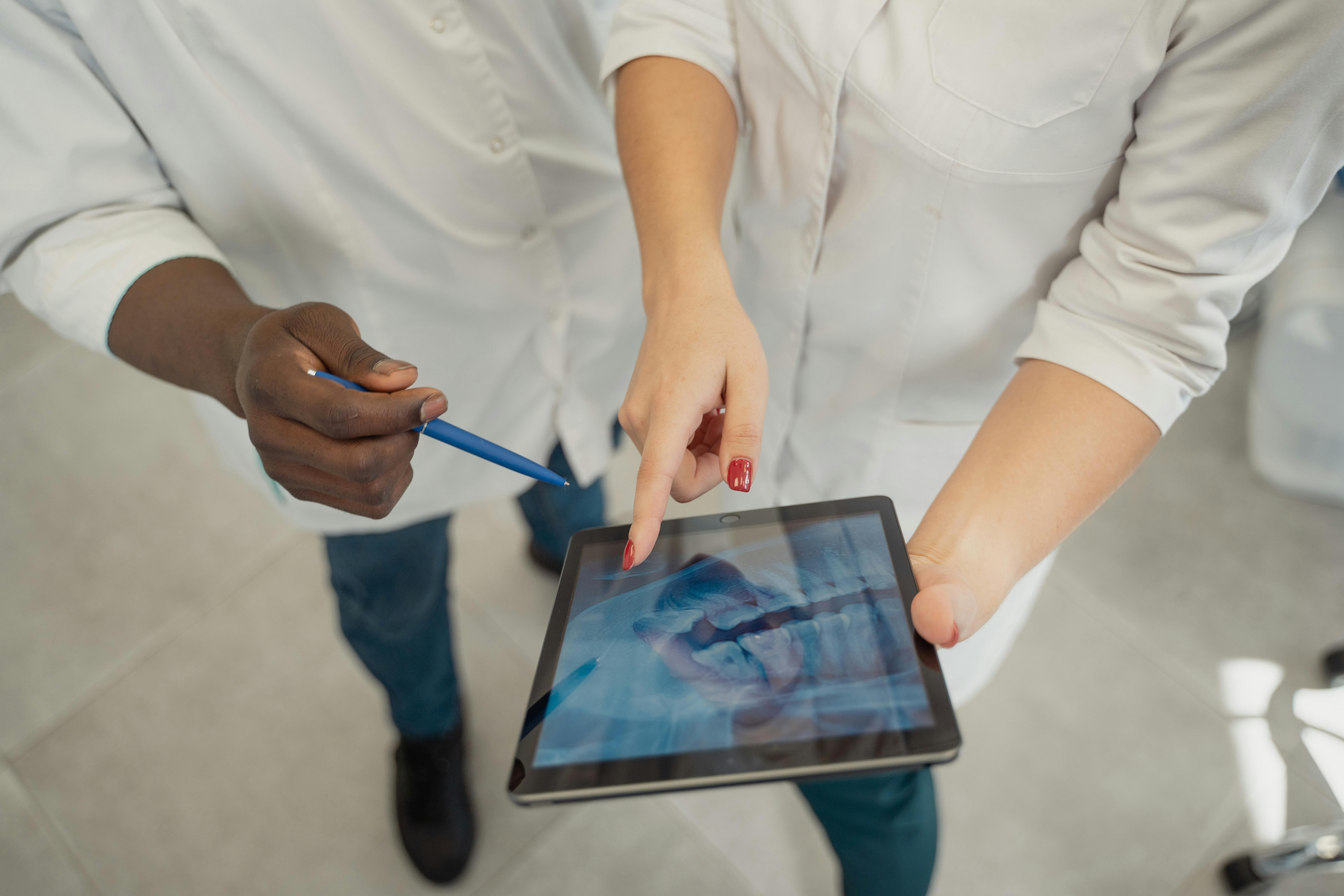 Ipad held by Dentists 