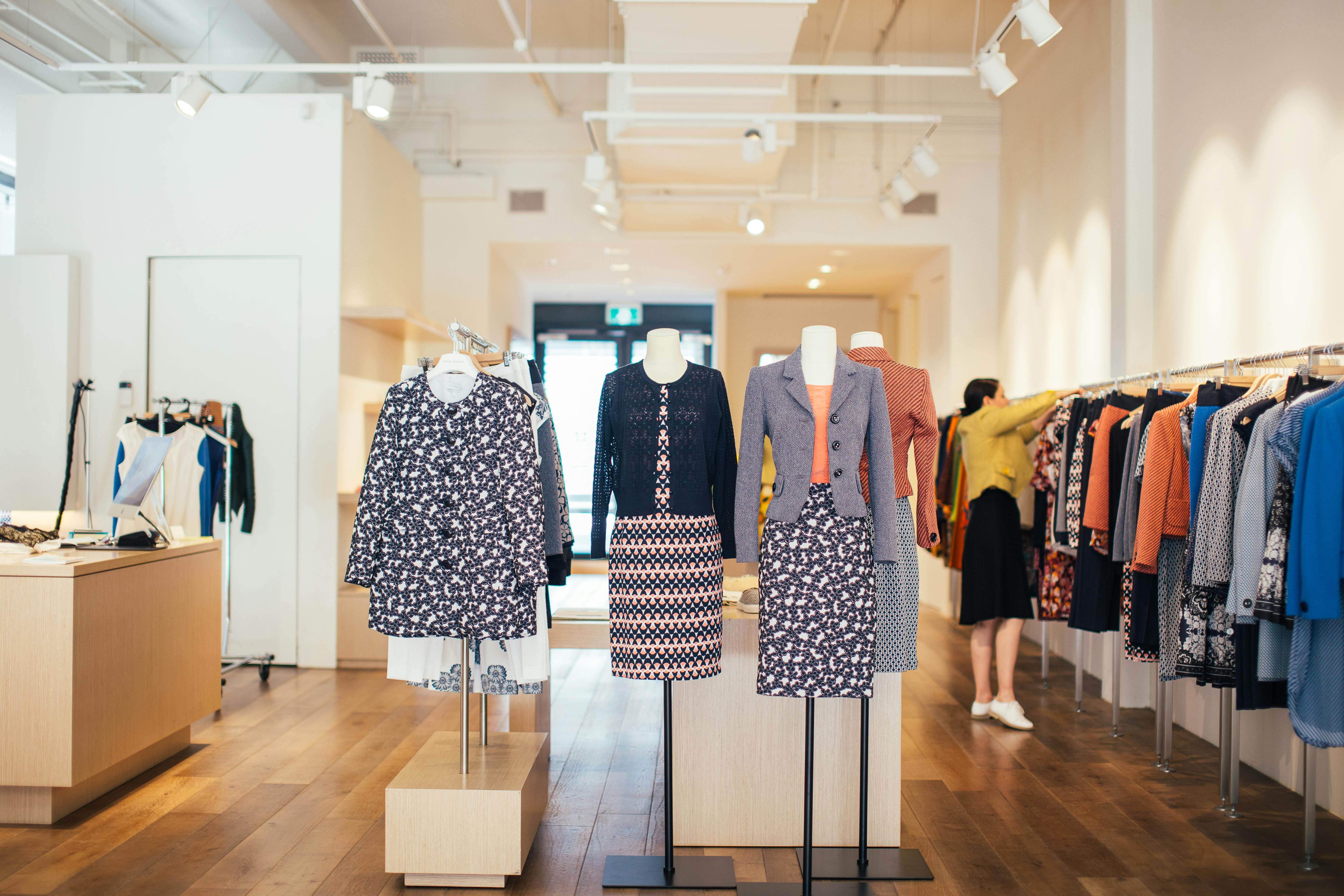 Mannequins in trendy clothes placed in stylish shop