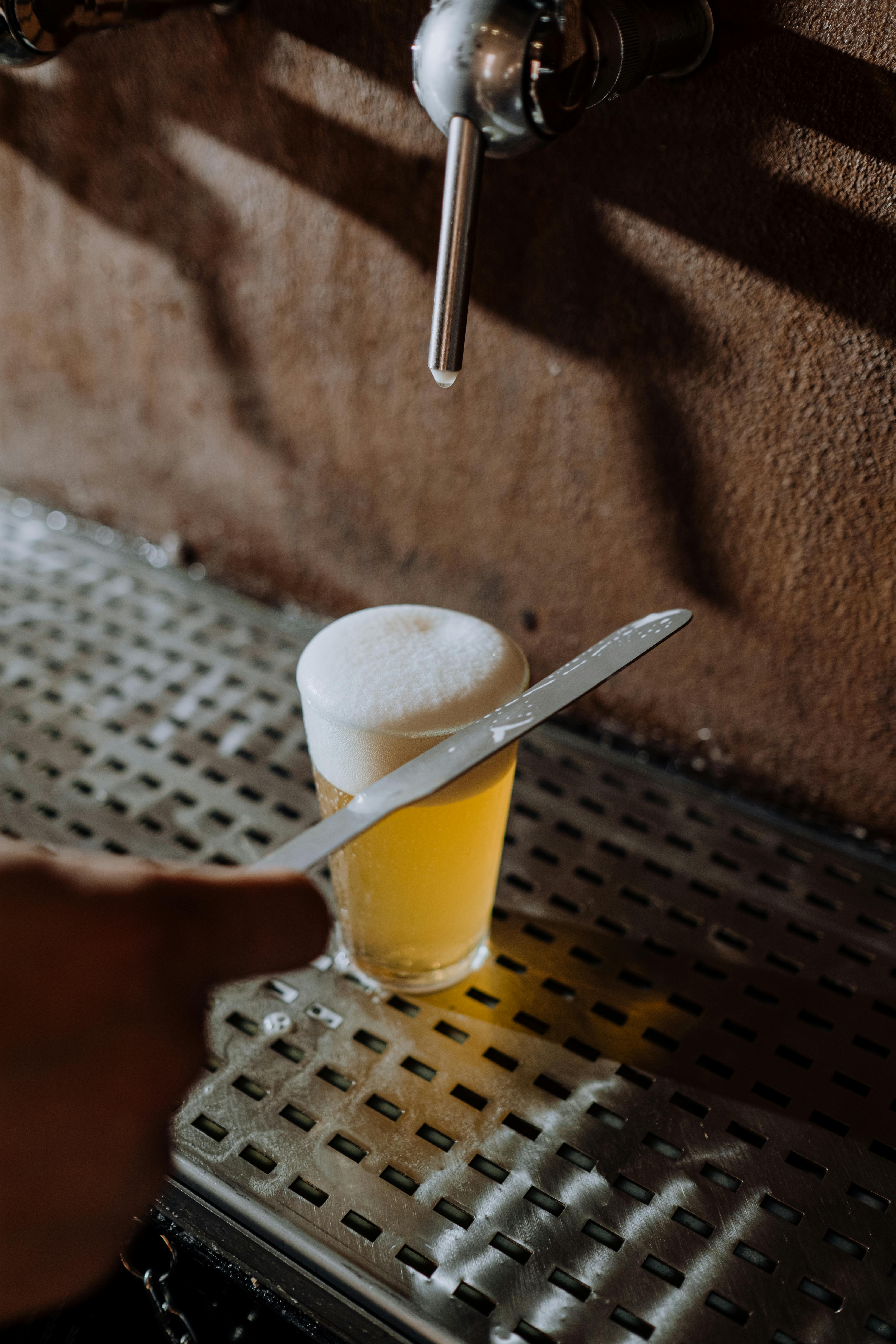Beer in a Glass on a Metal Surface