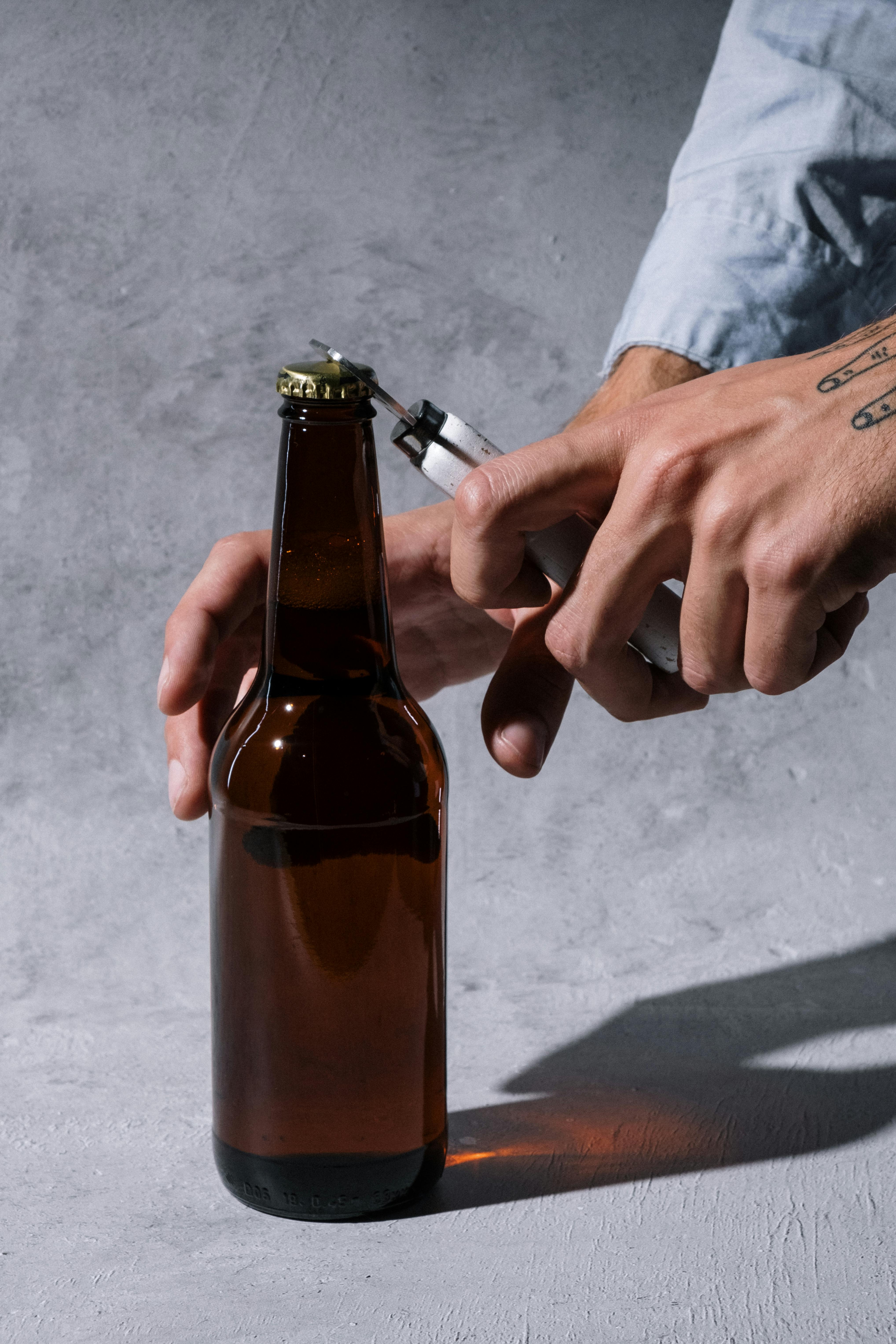 A Person Holding Brown Glass Bottle