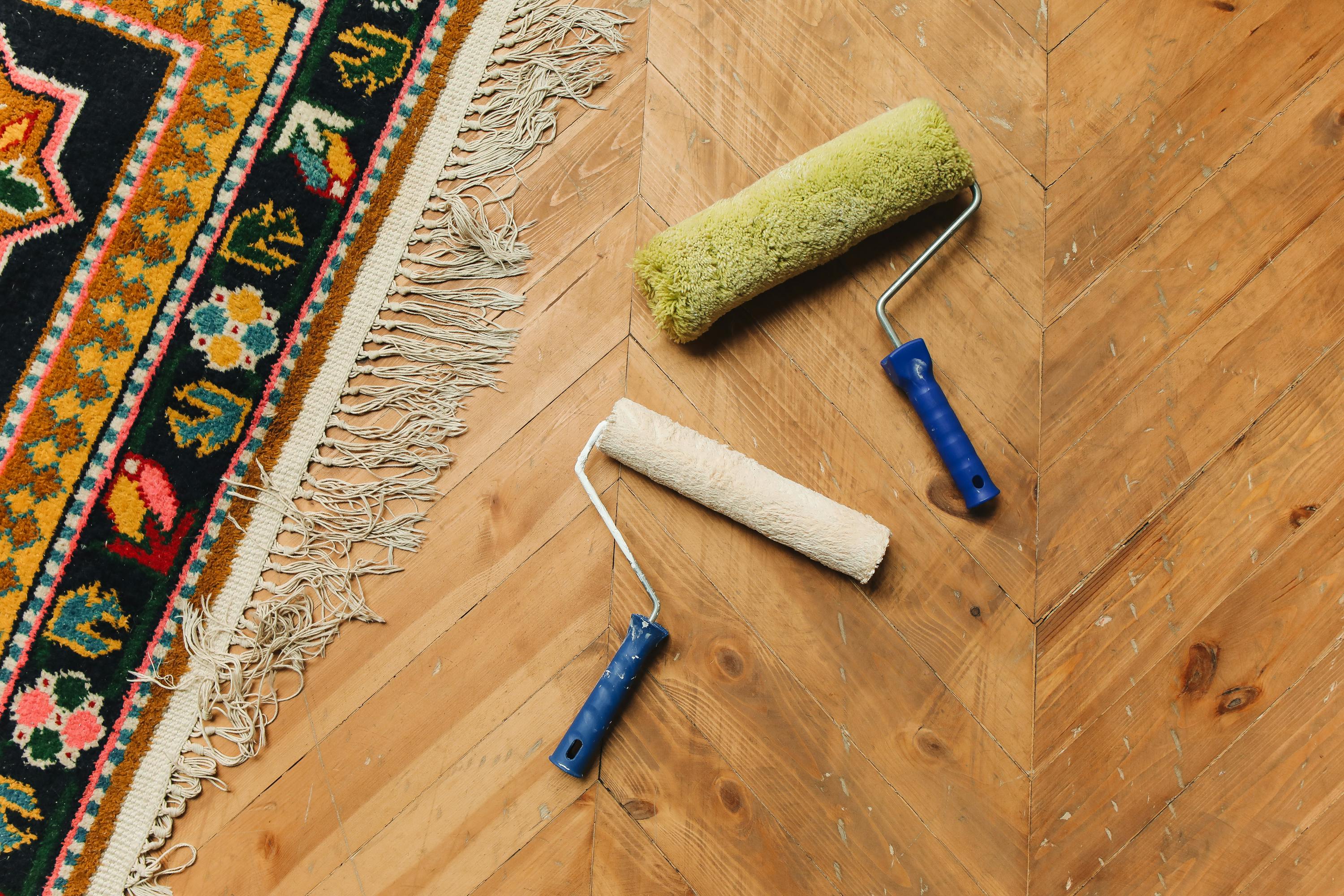 Paint Rollers Lying on a Wooden Floor 