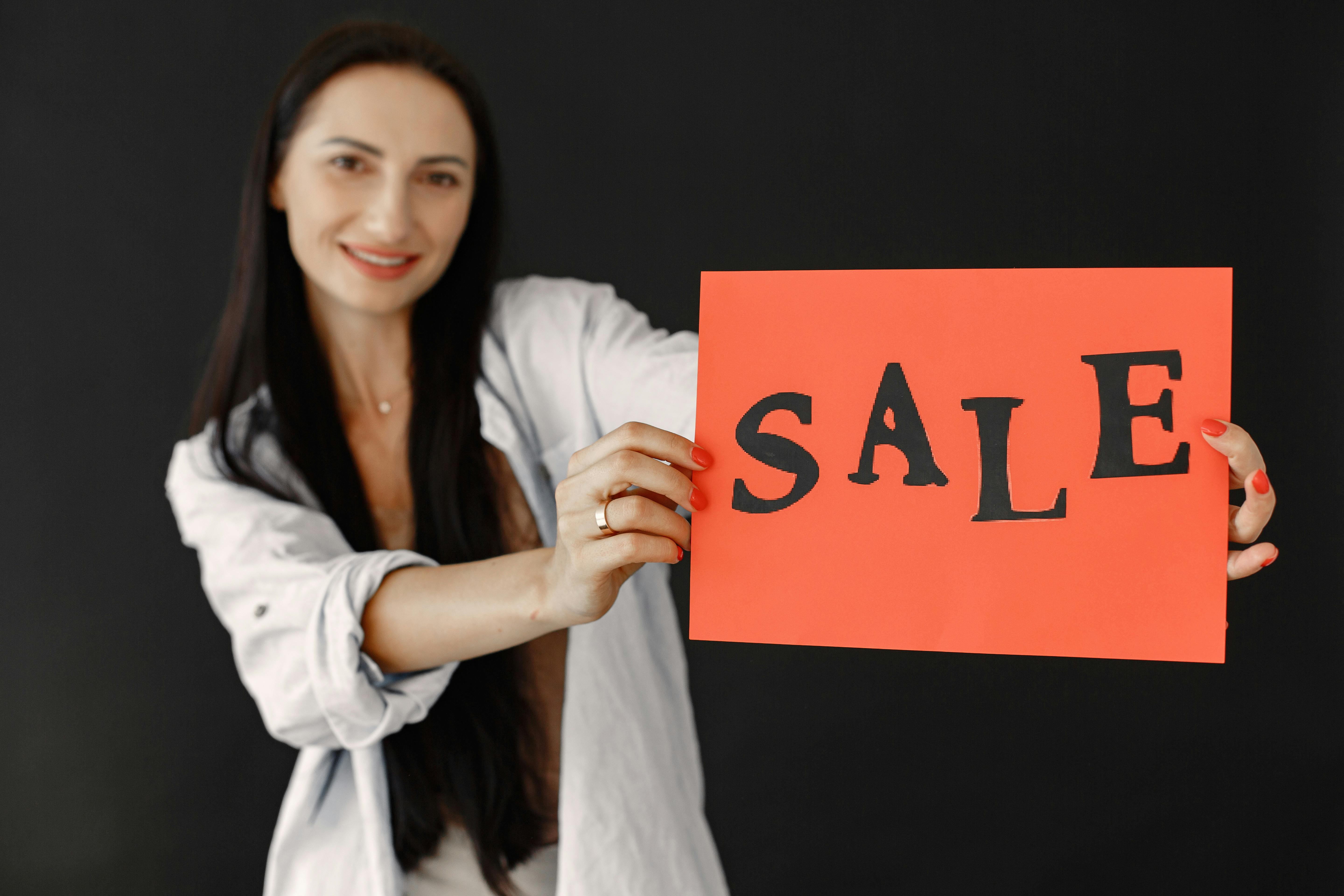 Woman with Sale Text on Paper Sheet