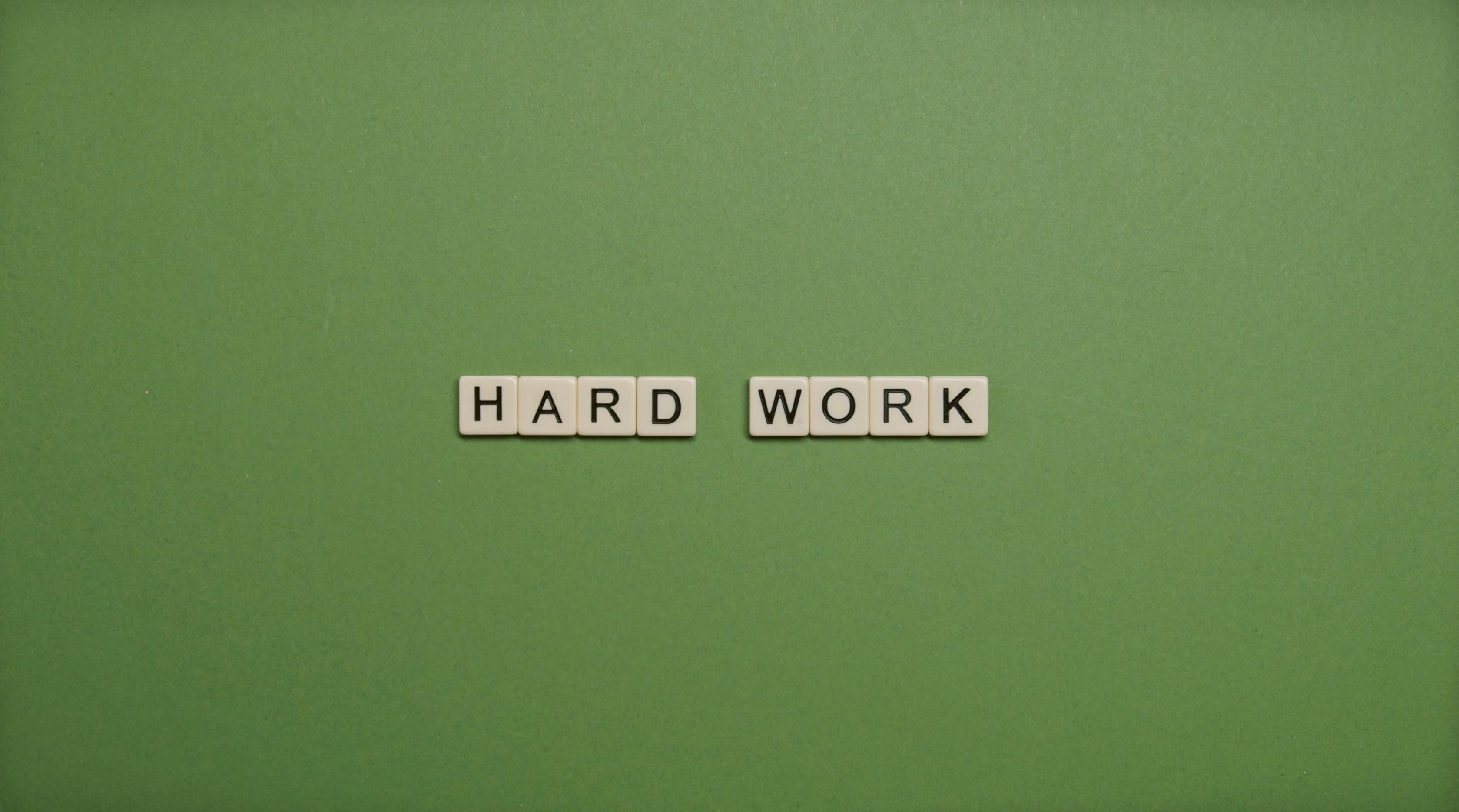 Hard Work Text On Green Background