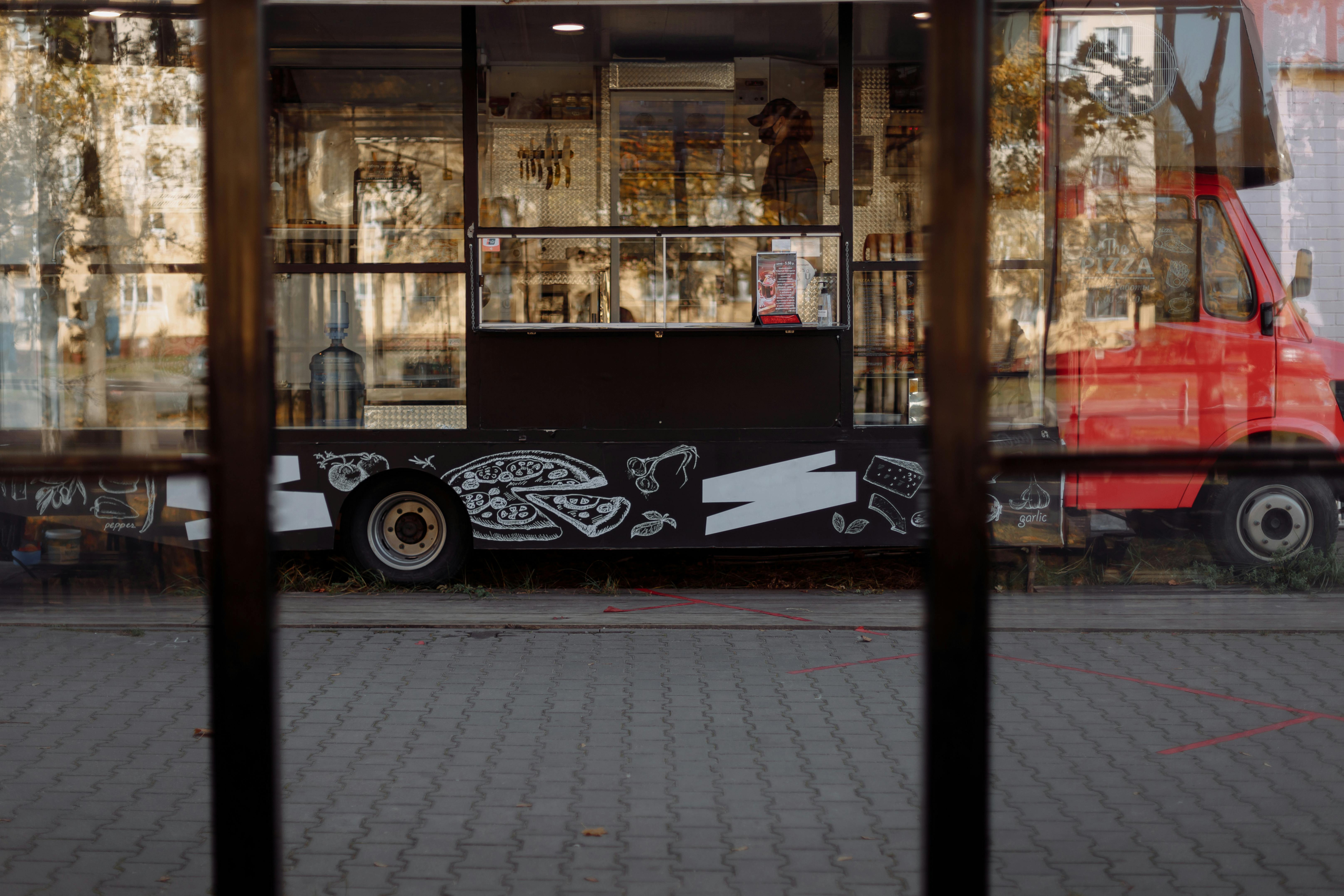 Red Food Truck Parked on Sidewalk 