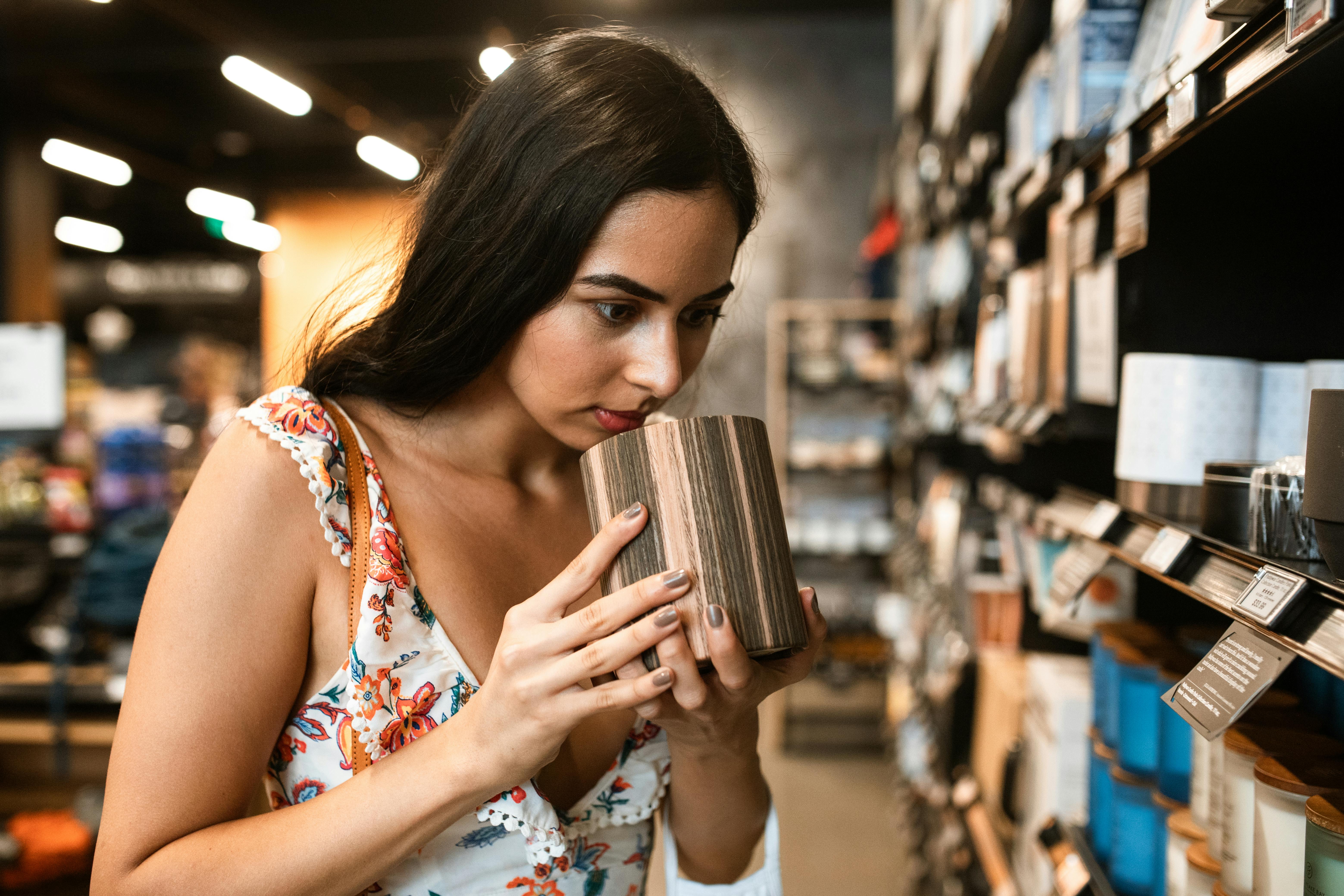 Woman Smelling A Scented Candle