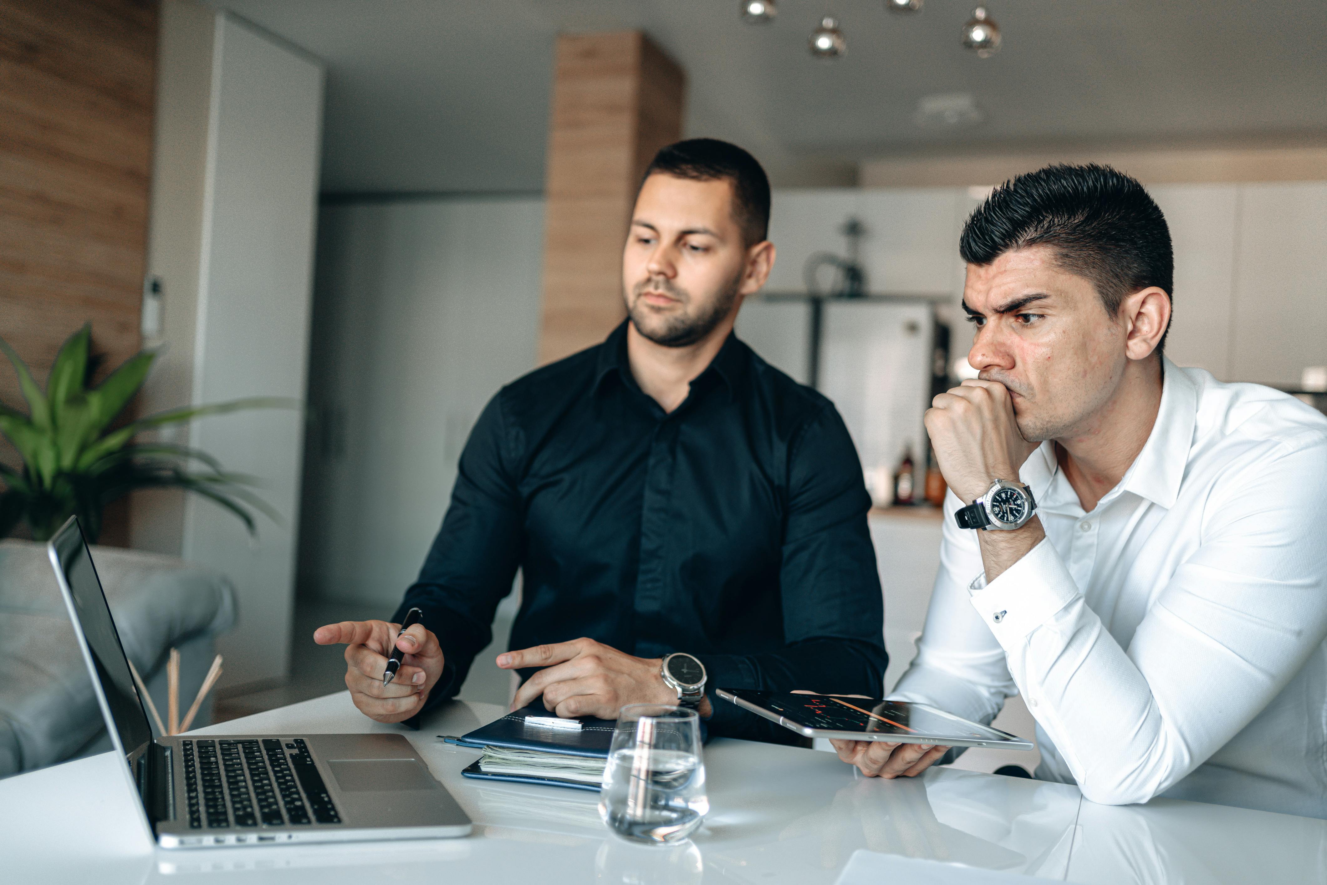 Business Men Seriously Looking at the Monitor of a Laptop
