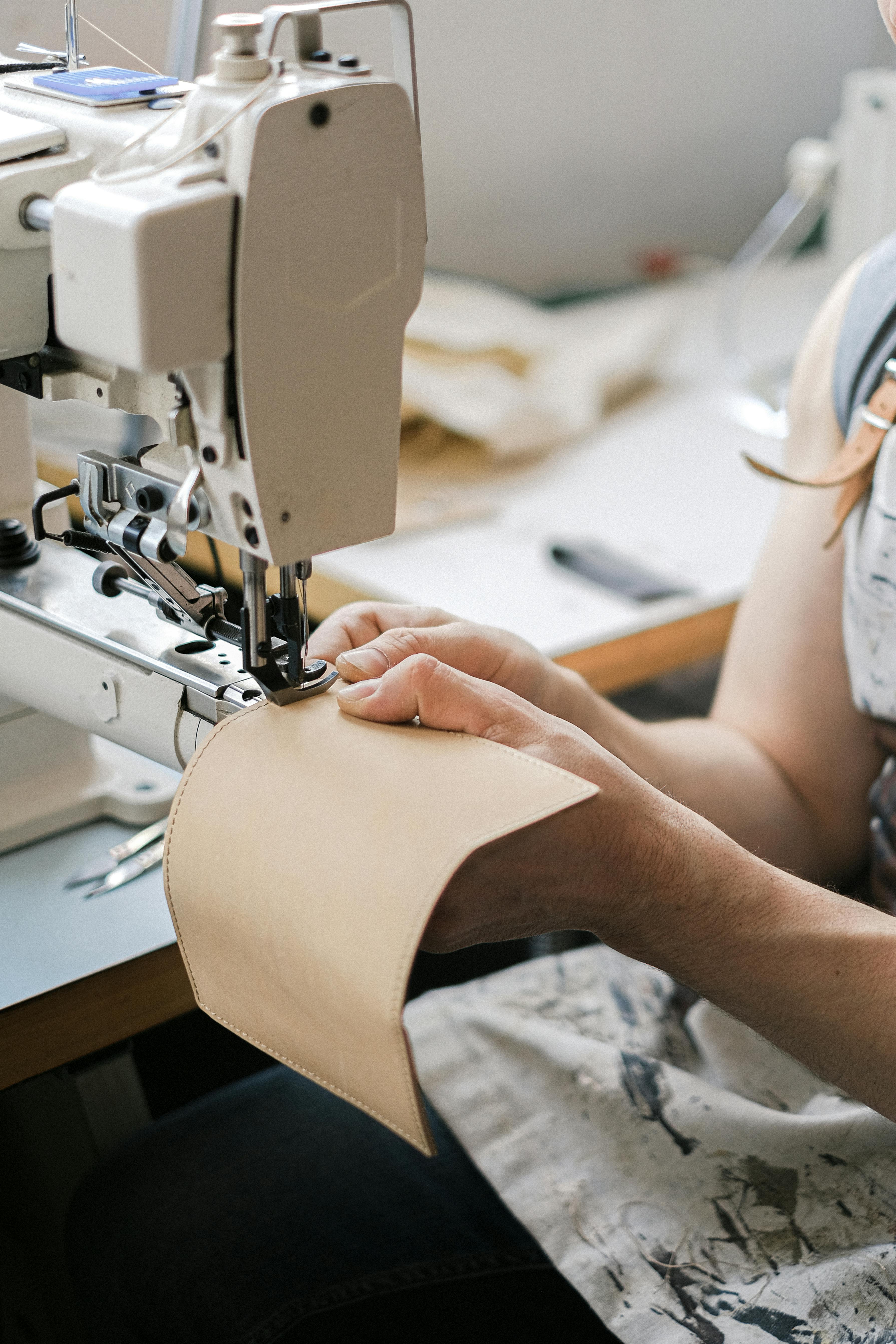 A Person Sewing Using Industrial Sewing Machine